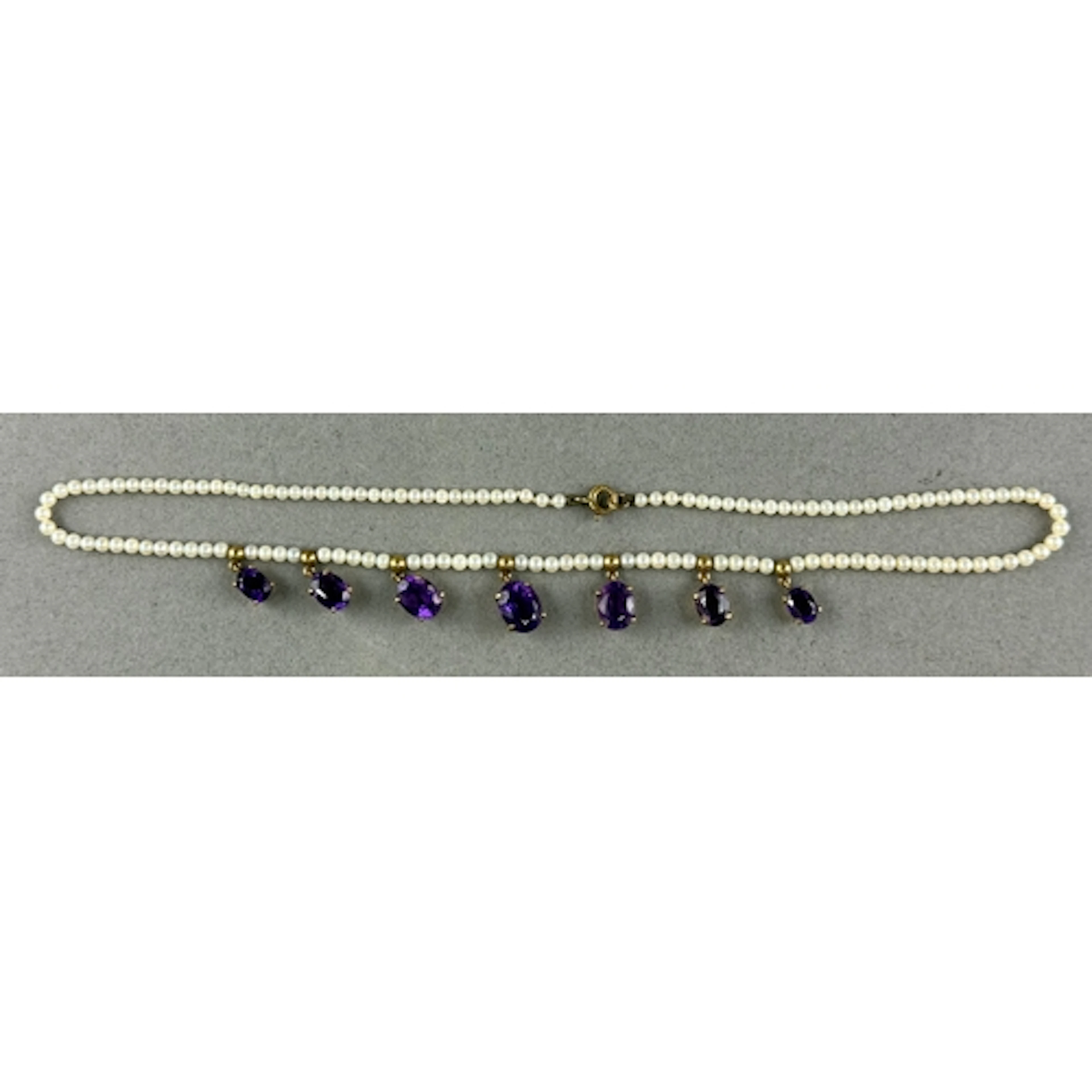Jewellery: a 9ct gold mounted seed pearl necklace, with seve...