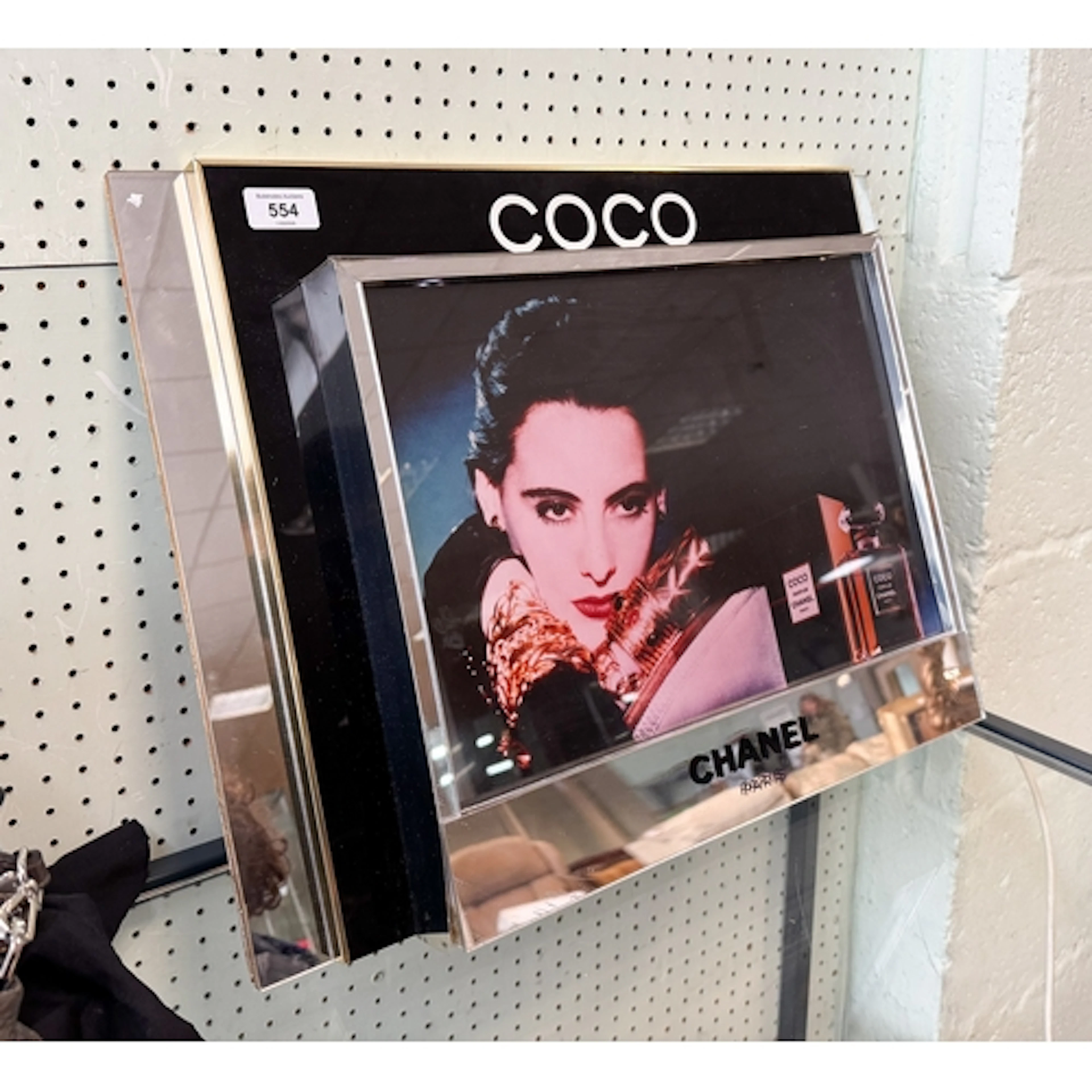A Coco Chanel illuminated display advertising mirror