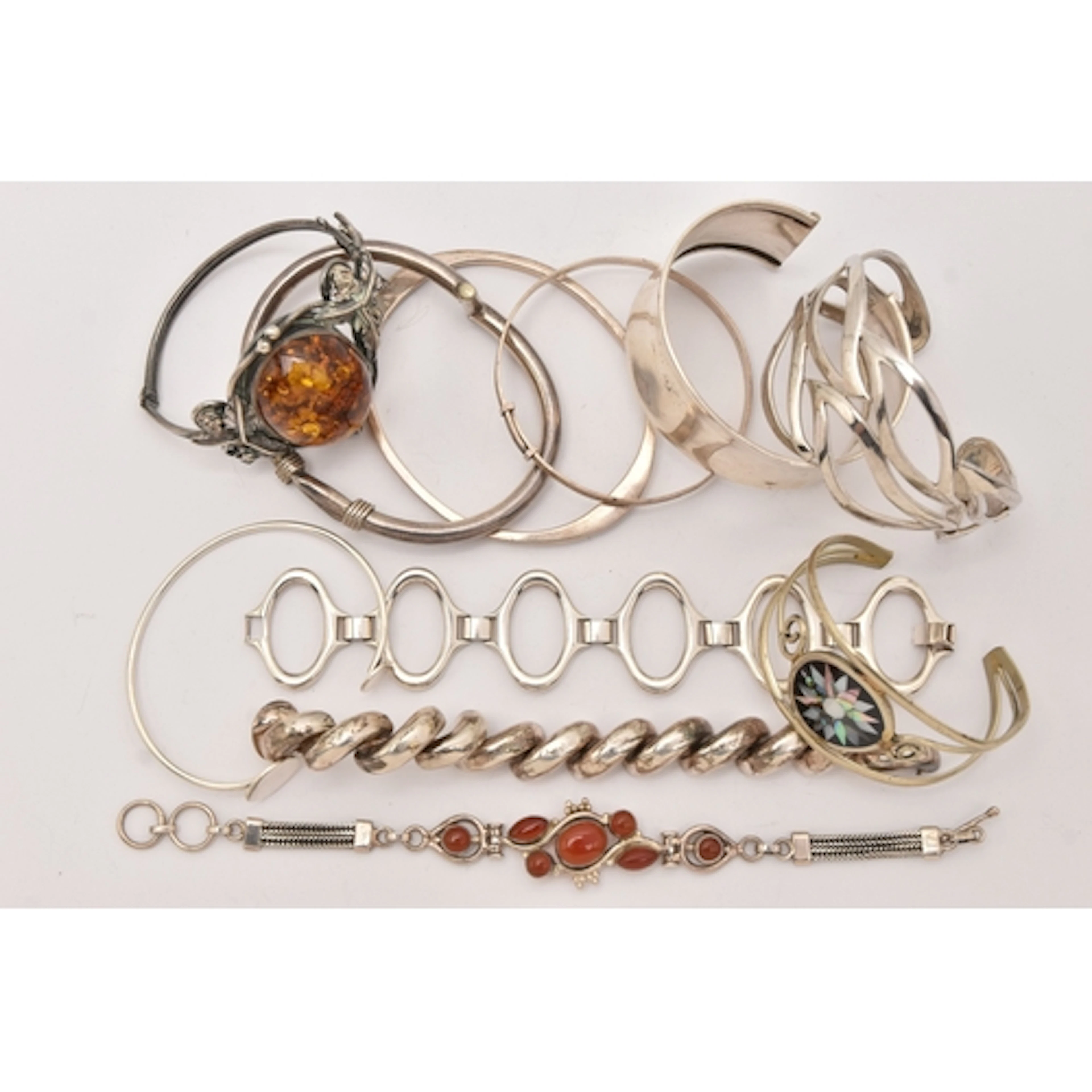 AN ASSORTMENT OF WHITE METAL BRACELETS, to include three cuf...