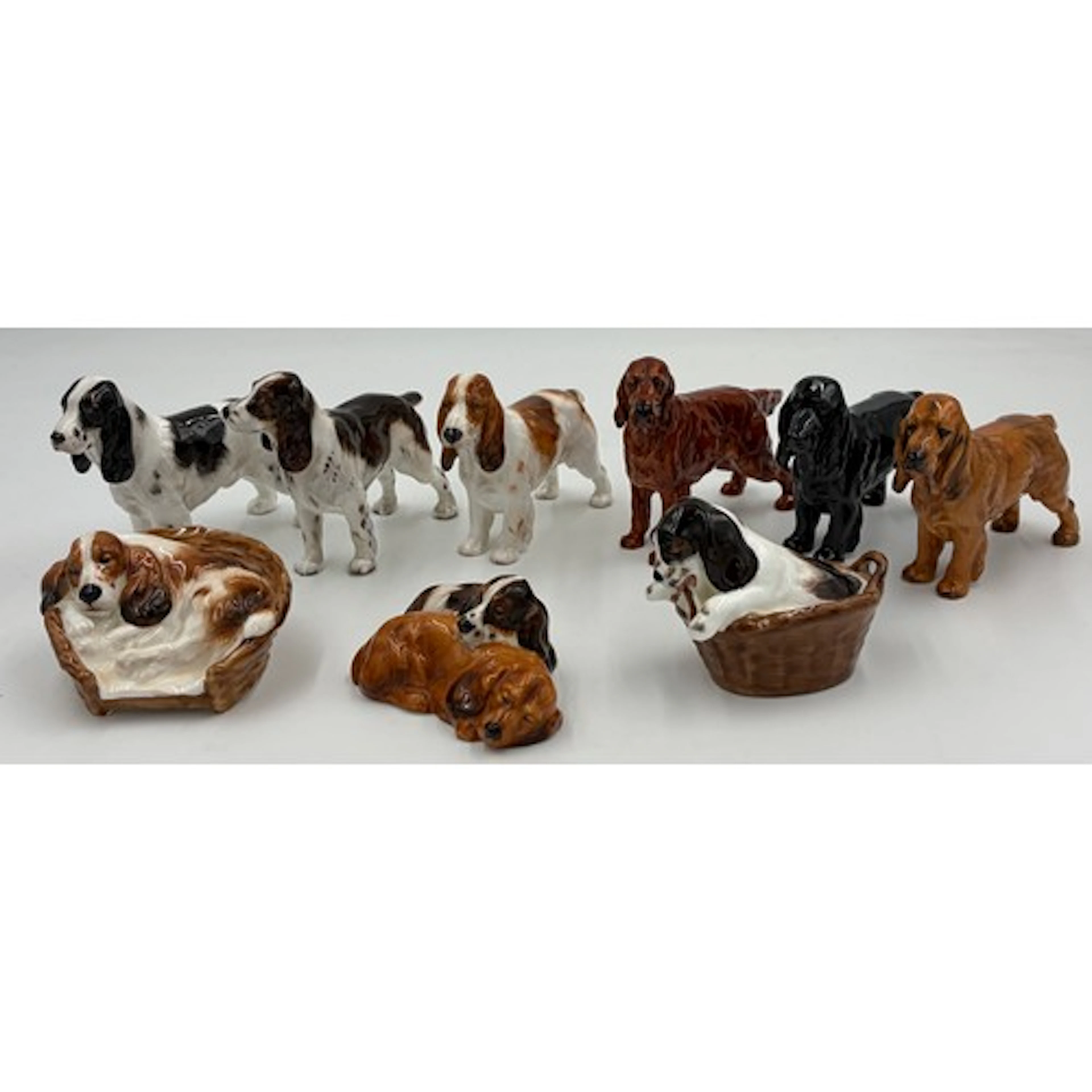 A collection of Royal Doulton dogs to include: 4 x Cocker Sp...
