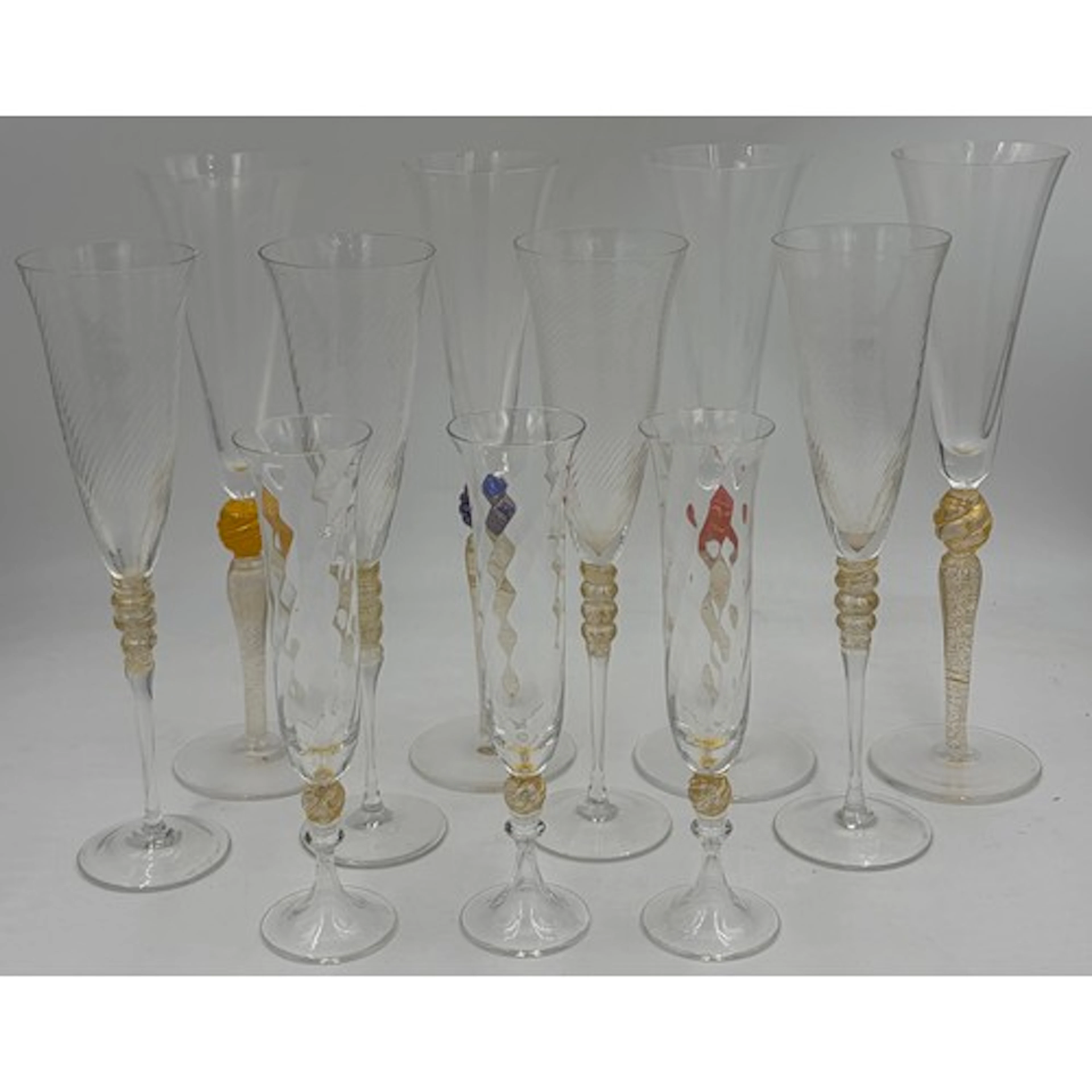 A collection of Murano champagne flutes 24 carat gold to inc...