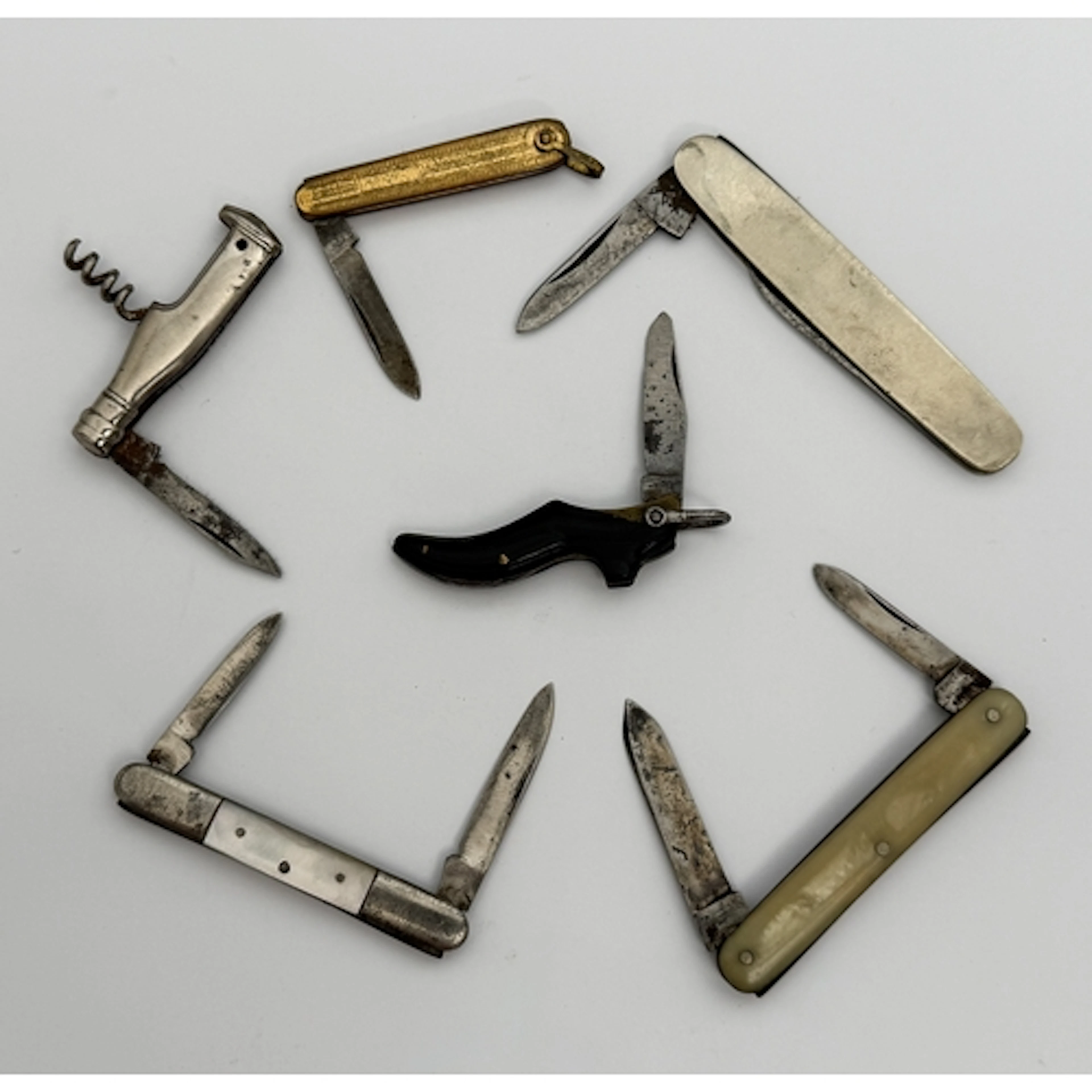 Six small vintage penknives - one in the form of a lady's sh...