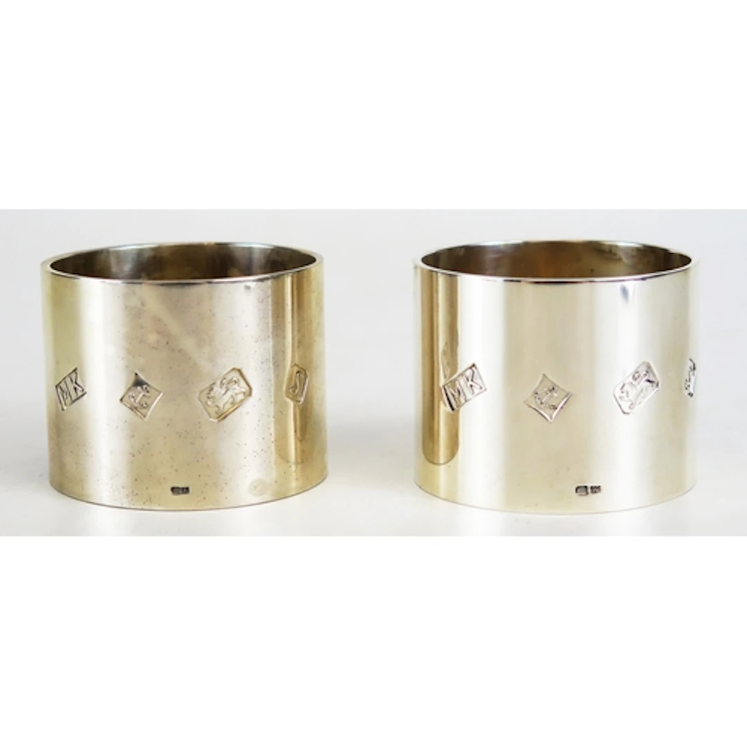 A pair of Elizabeth II silver napkin rings, maker M Kamin & ...