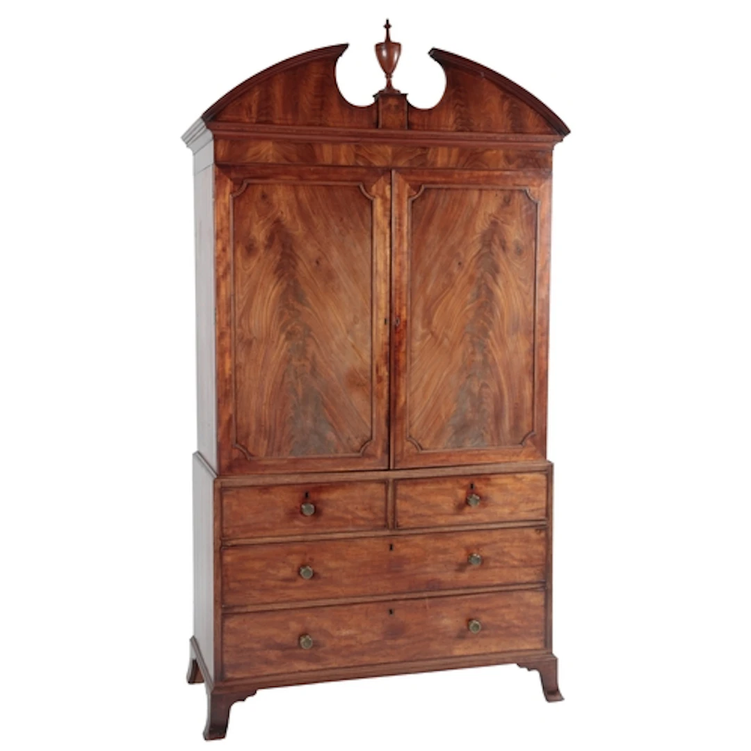A George III Sheraton period mahogany linen press, the mould...