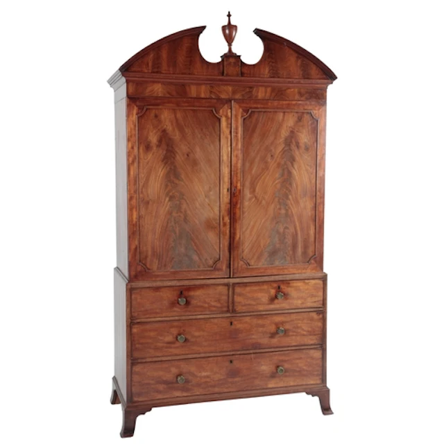 A George III Sheraton period mahogany linen press, the mould...