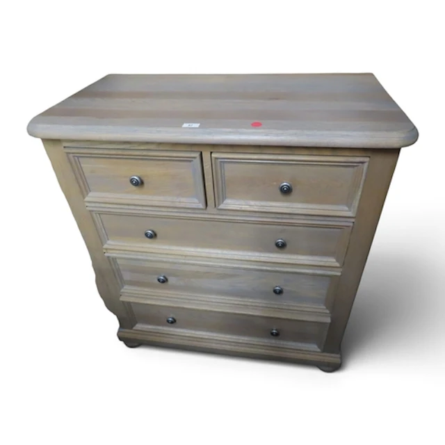 A contemporary limed oak finished chest of drawers with two ...