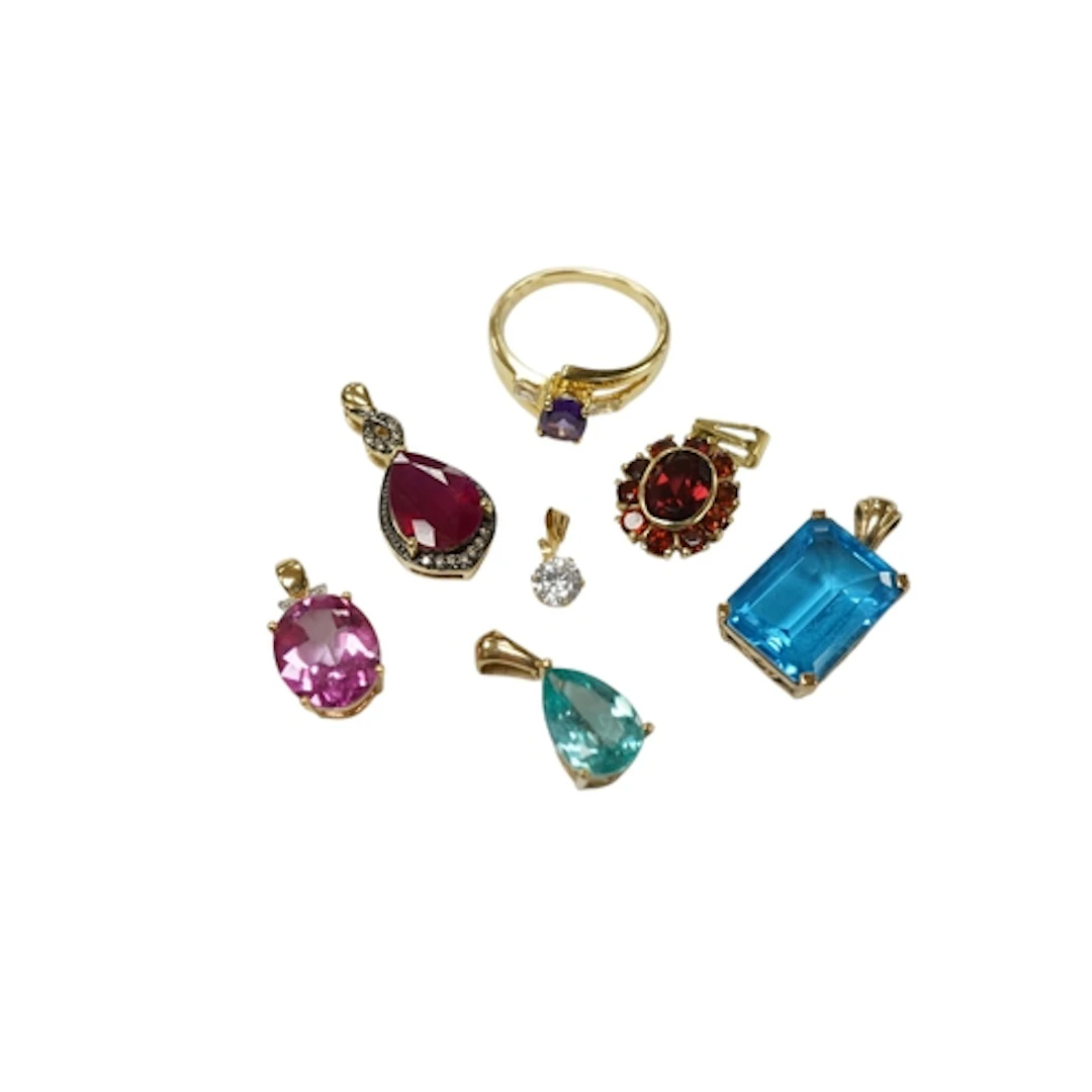 A collection of modern synthetic and paste pendants includin...