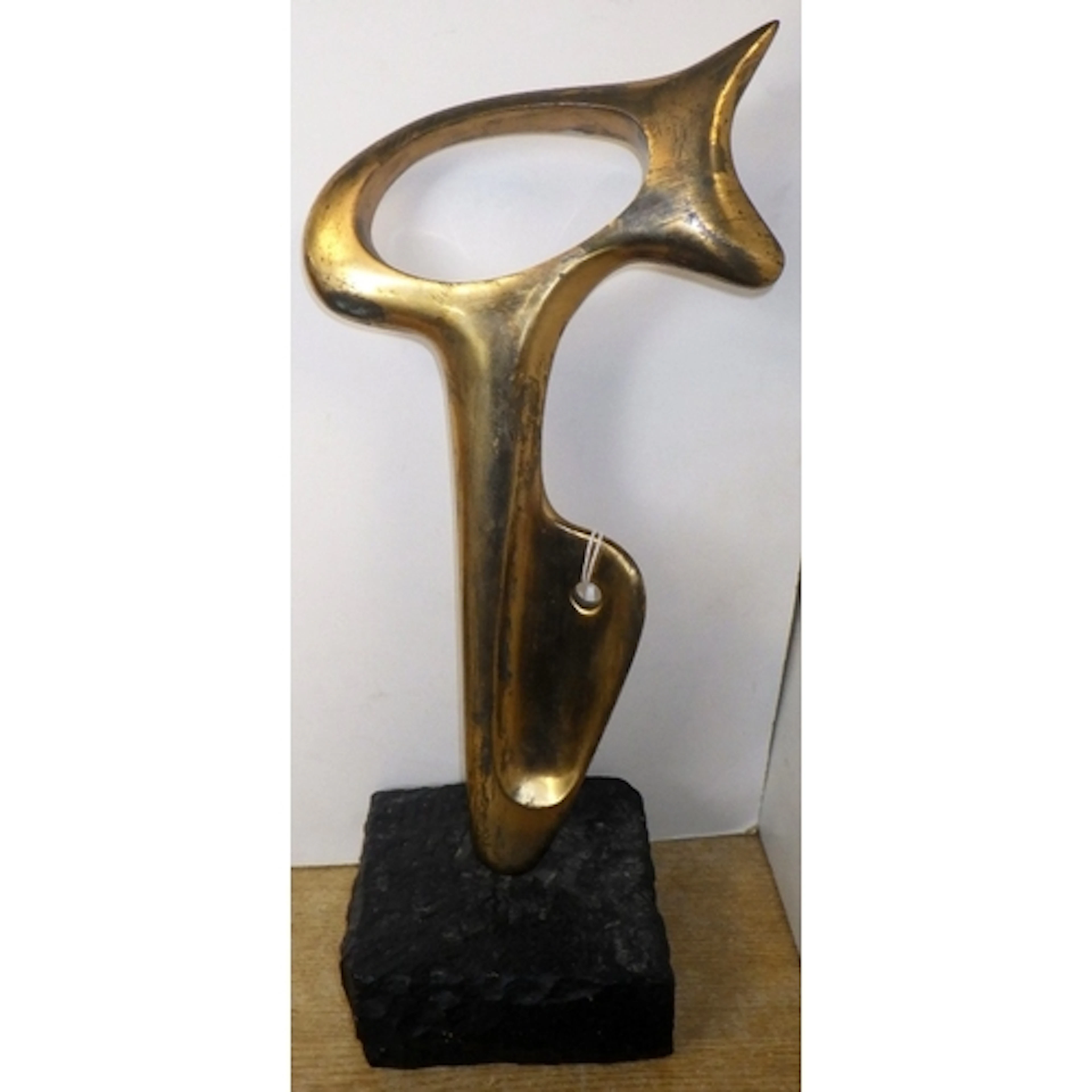 An abstract bronze sculpture on a marble base