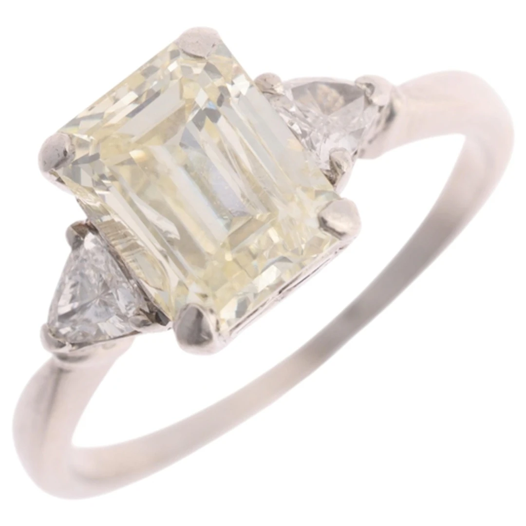 A platinum three stone diamond ring, claw set with 1.85ct em...