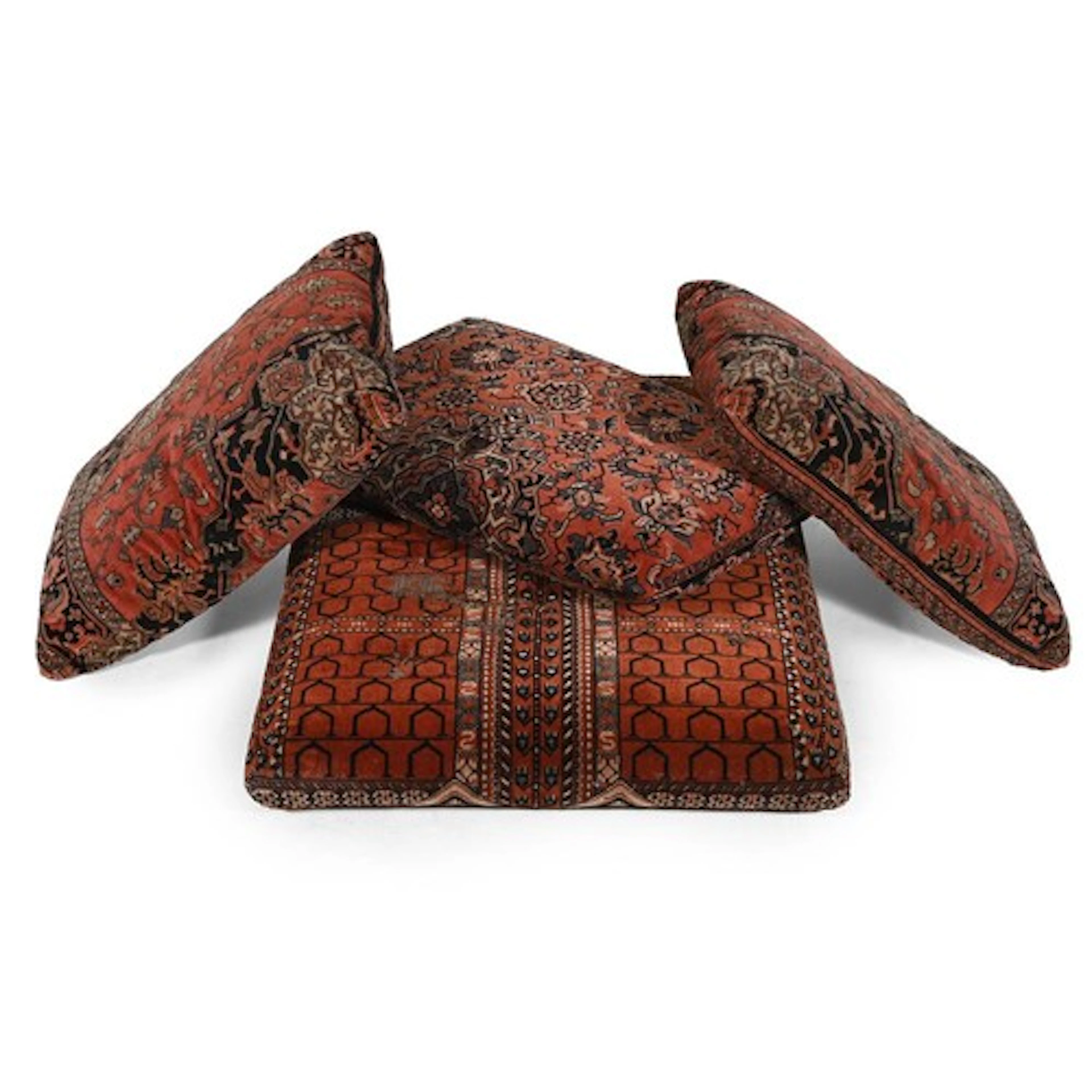A group of four carpet upholstered floor cushions, probably ...