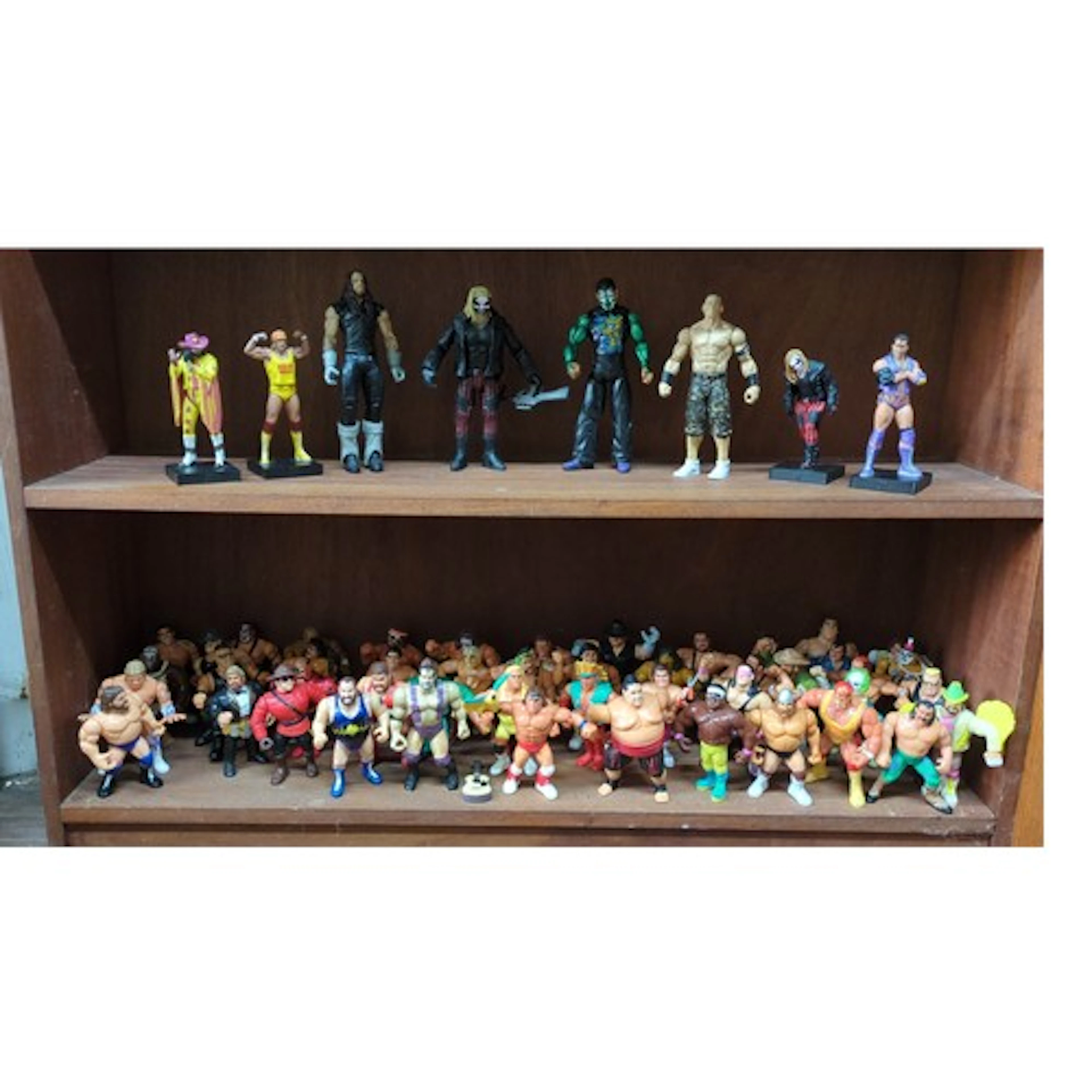 A group of WWF/WWE-style wrestling action figures and displa...