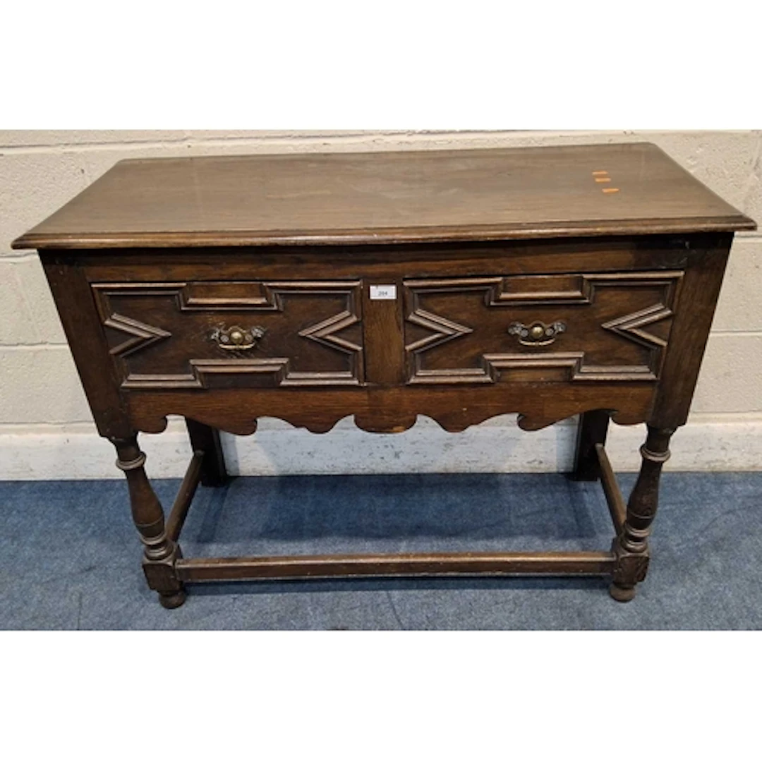 AN EARLY 20TH CENTURY OAK SIDEBOARD, fitted with two drawers...