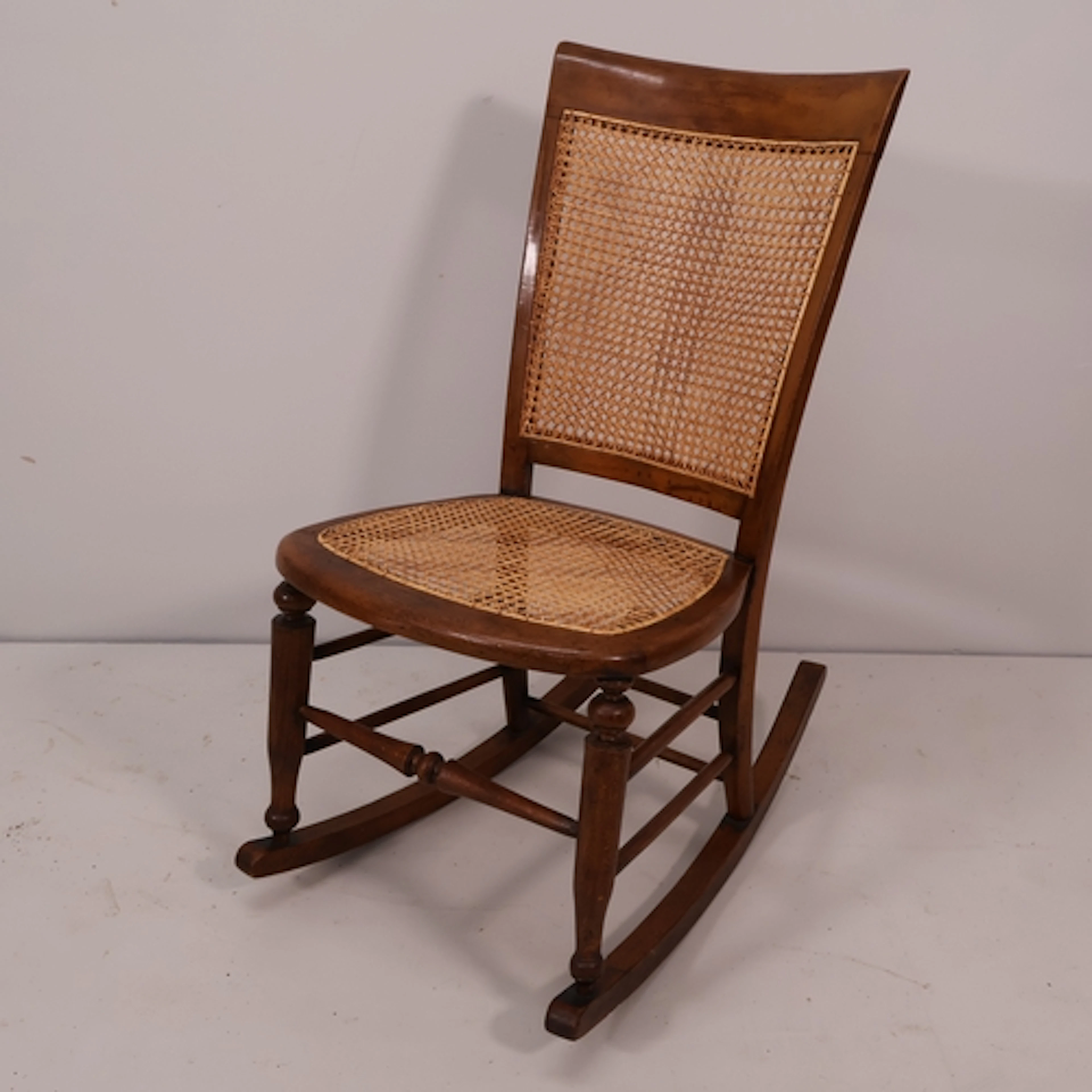 A 19th century mahogany and cane seated rocking chair