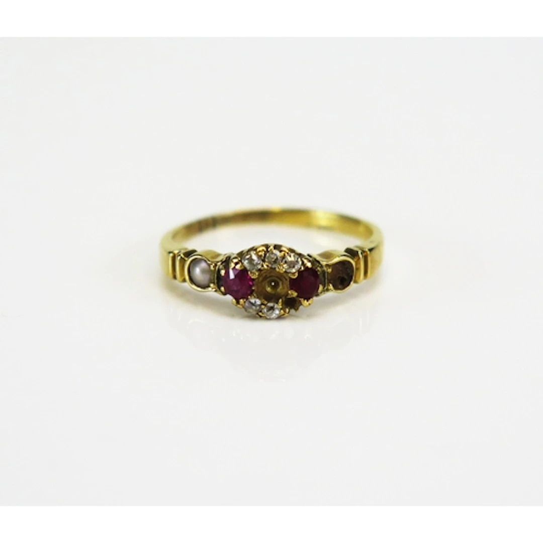 A high carat precious yellow metal gem and paste set cluster...