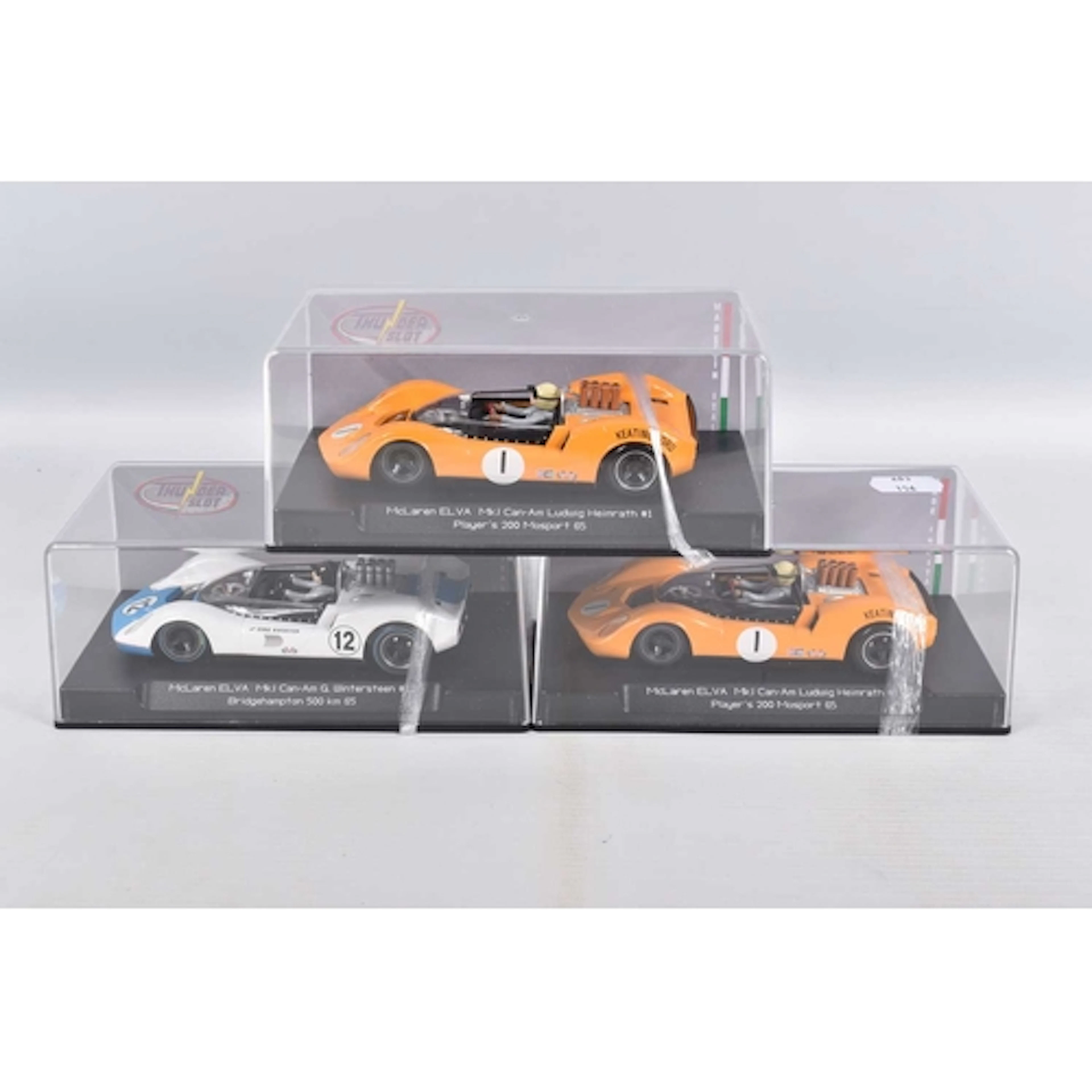 THREE CASED THUNDER SLOT MODEL SLOT CARS, to include two McL...