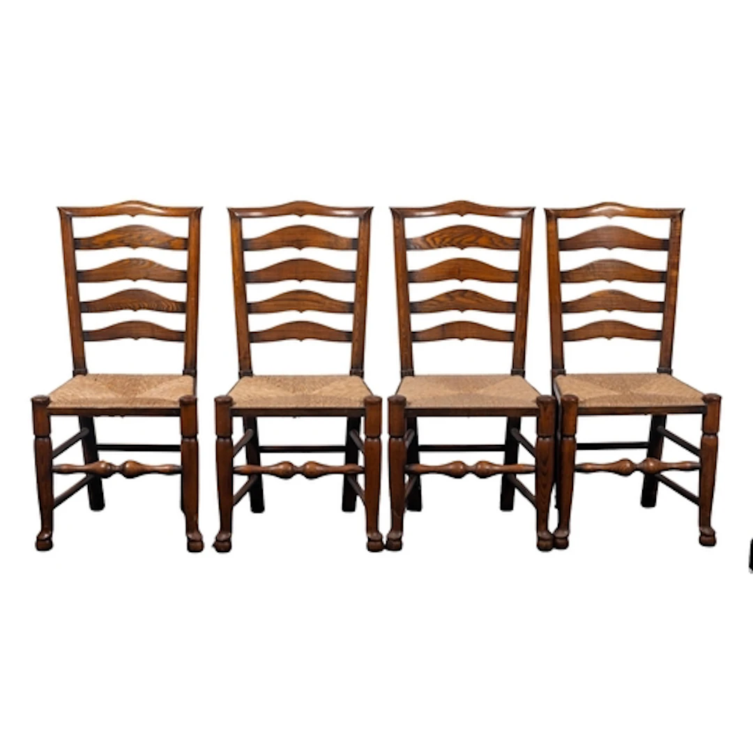 A set of six oak and rush seated ladder back dining chairs, ...