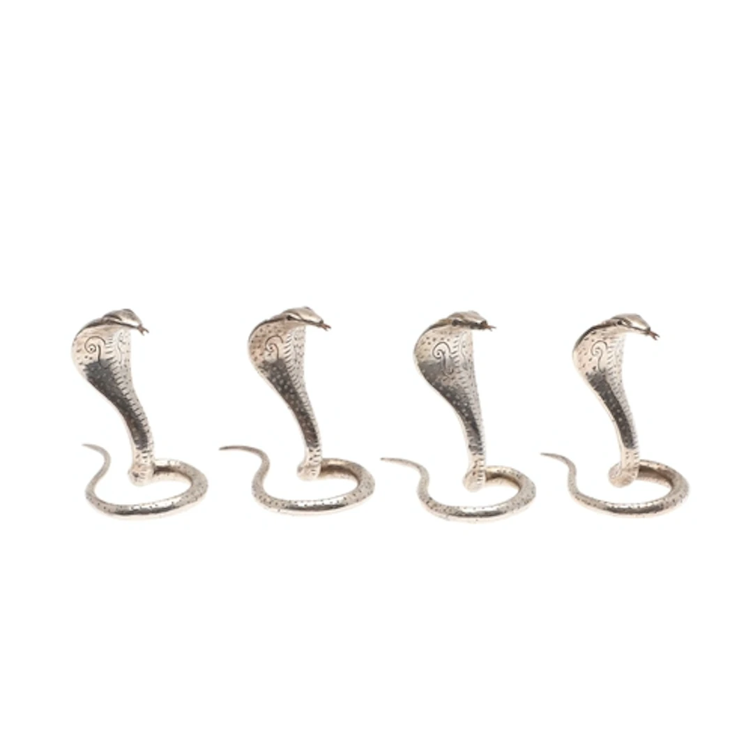 A SET OF FOUR SRI LANKAN SILVER PLACECARD HOLDERS IN THE FOR...
