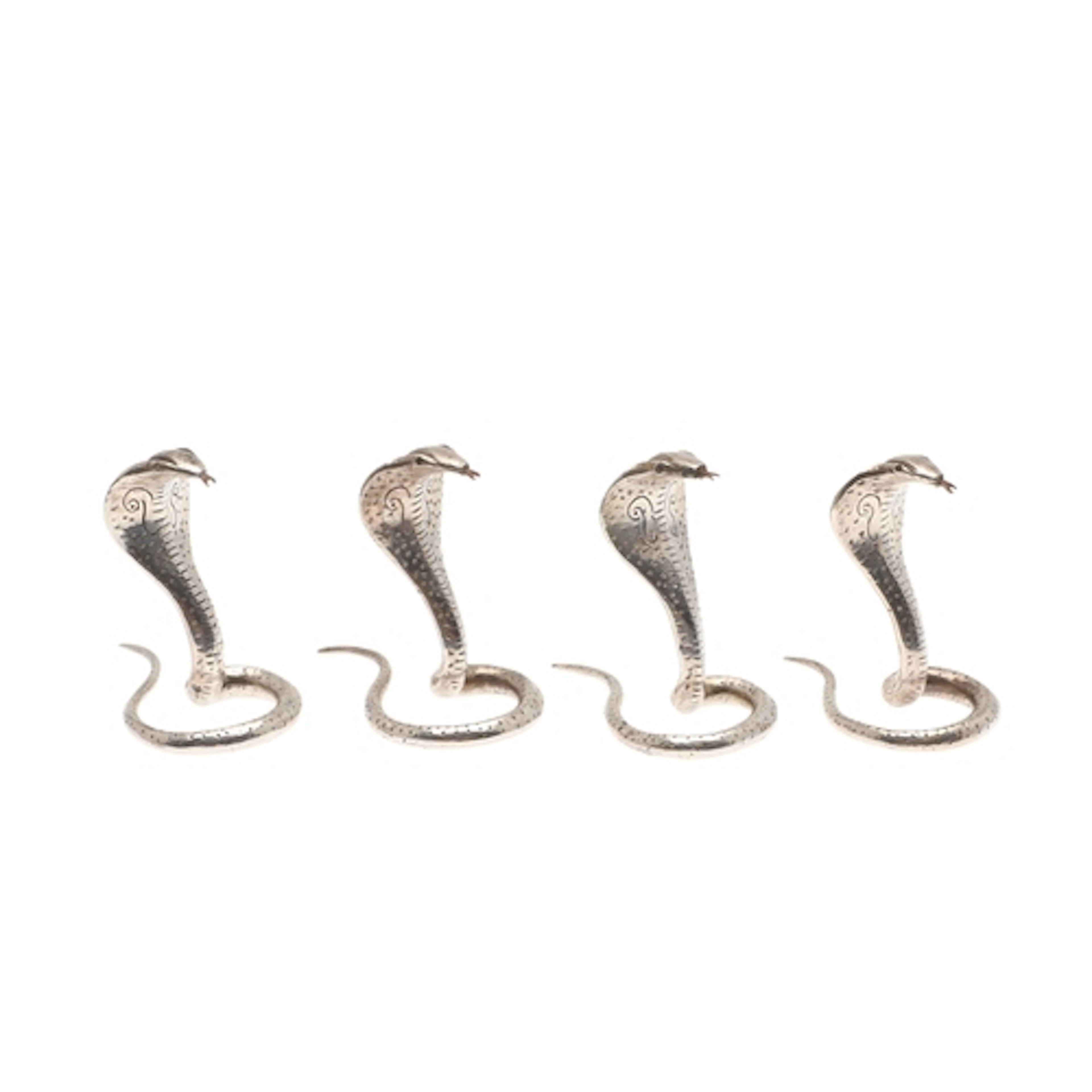 A SET OF FOUR SRI LANKAN SILVER PLACECARD HOLDERS IN THE FOR...