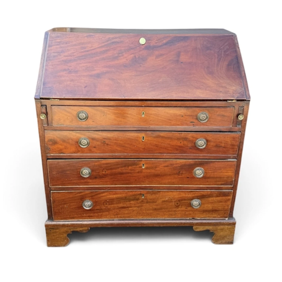 A GEORGE III MAHOGANY BUREAU With four long drawers under, 1...