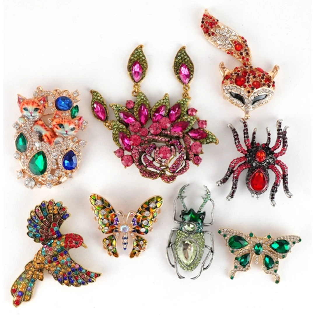 Eight decorative jewelled brooches, some with enamel, includ...