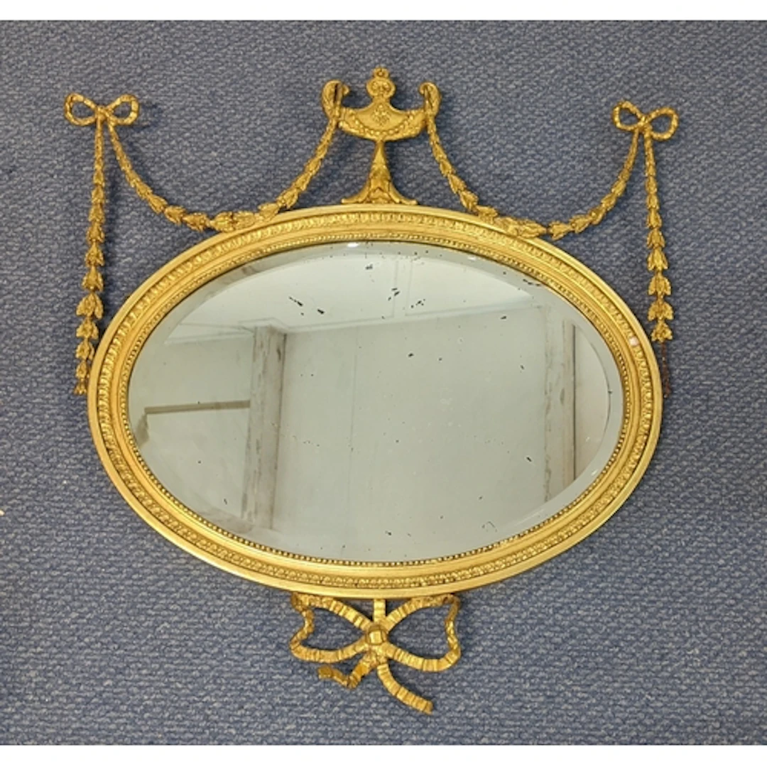 A 19th century giltwood wall mirror, having a bevelled plate...