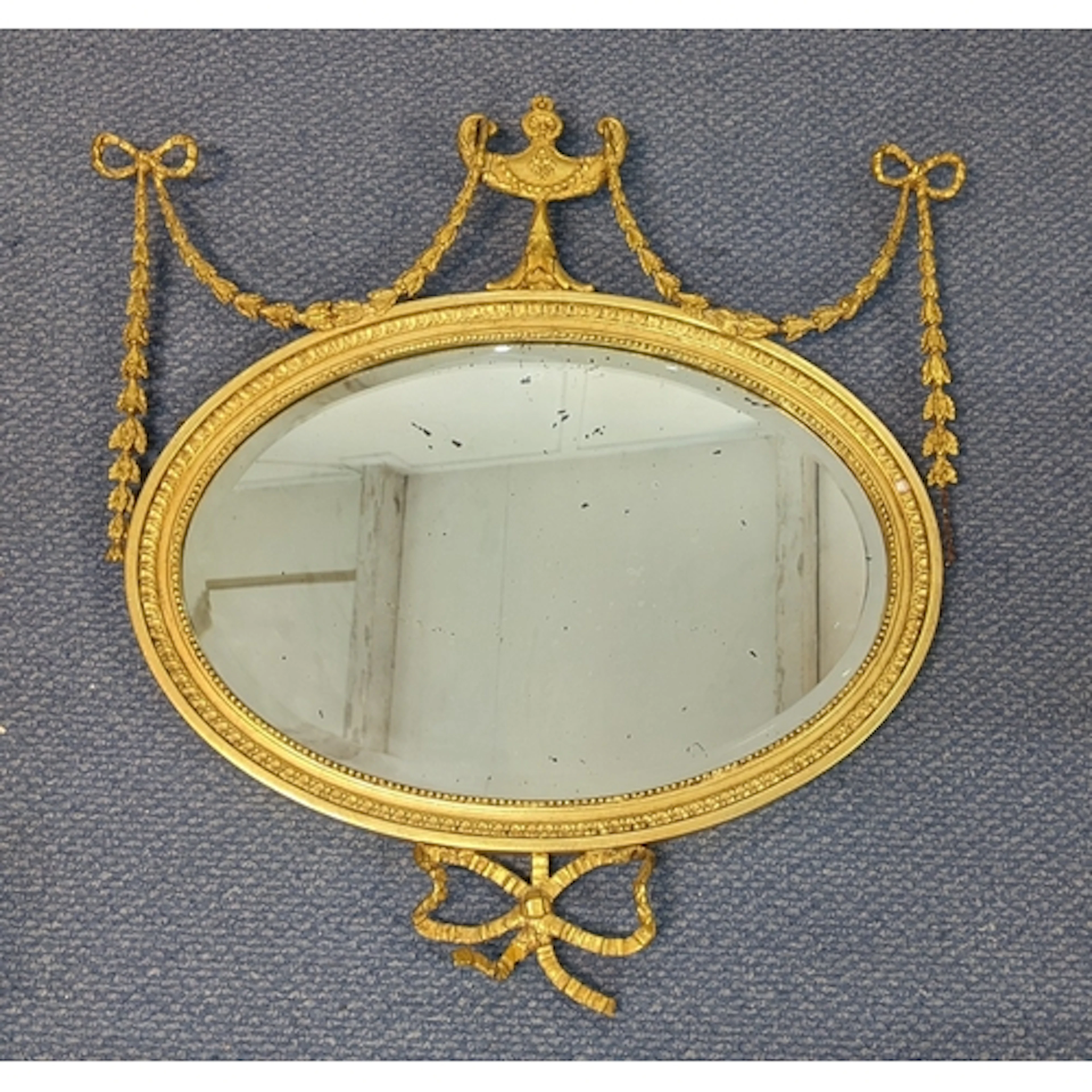 A 19th century giltwood wall mirror, having a bevelled plate...