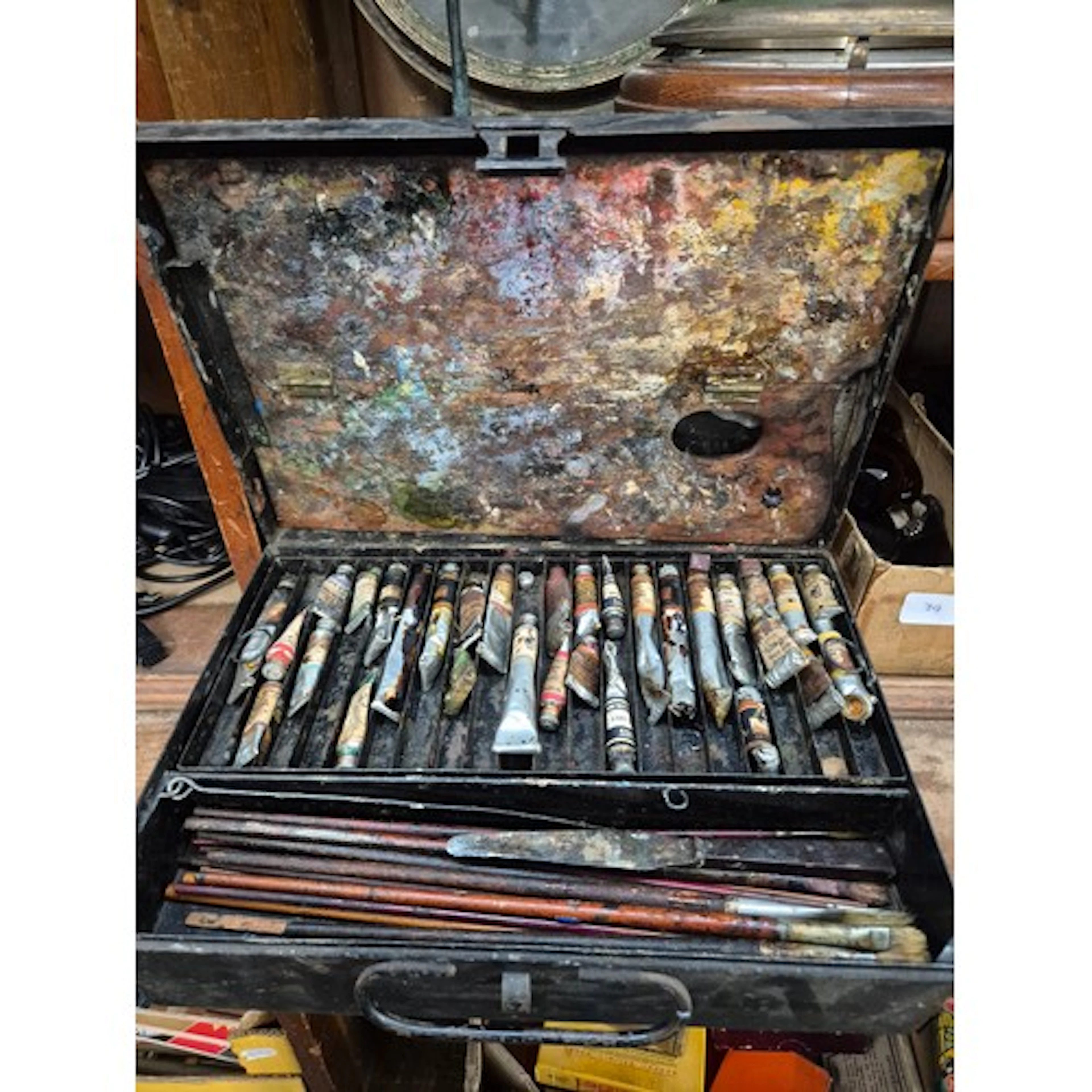 A metal artist's box containing a selection of oil paints.
