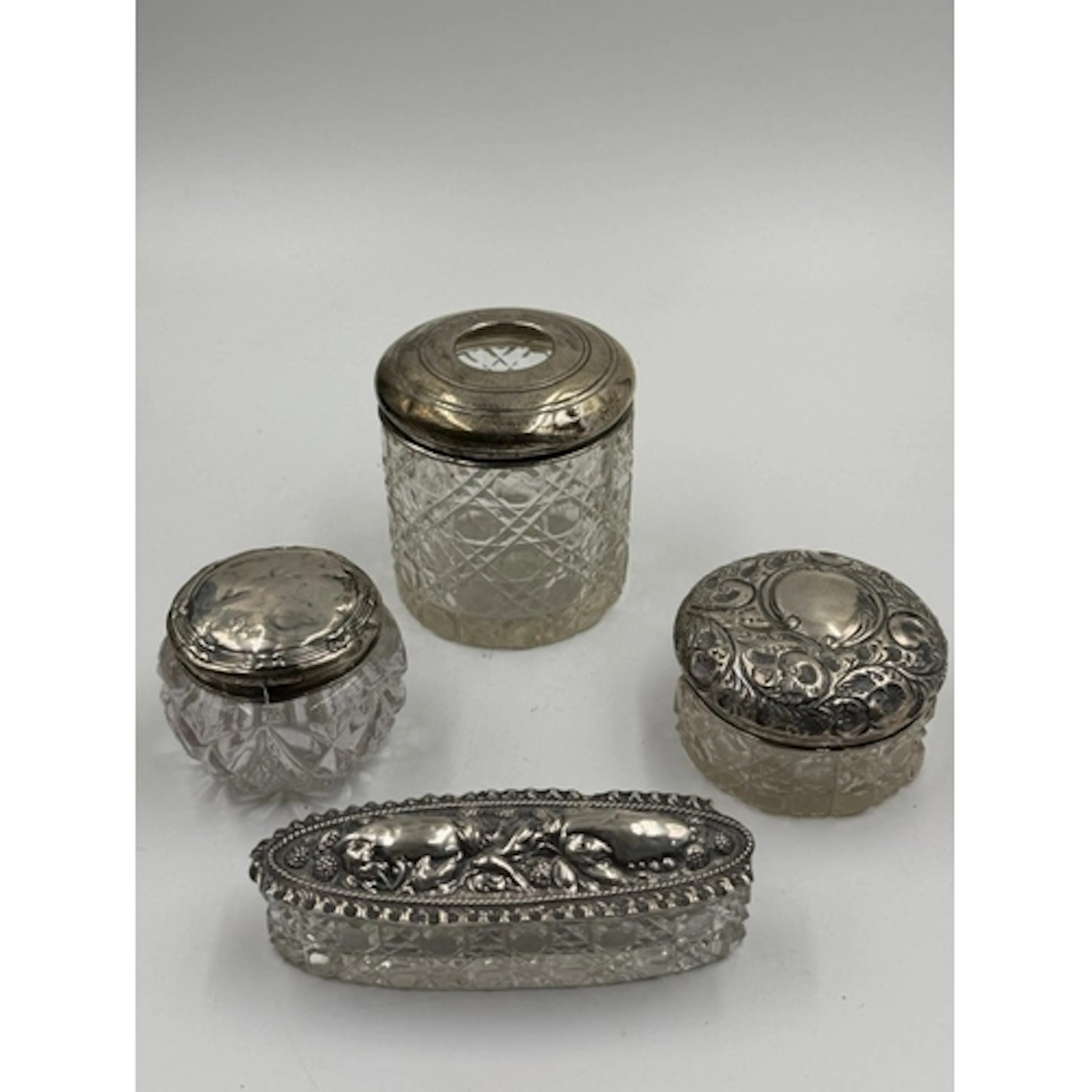 A collection of four silver topped cut glass dressing table ...