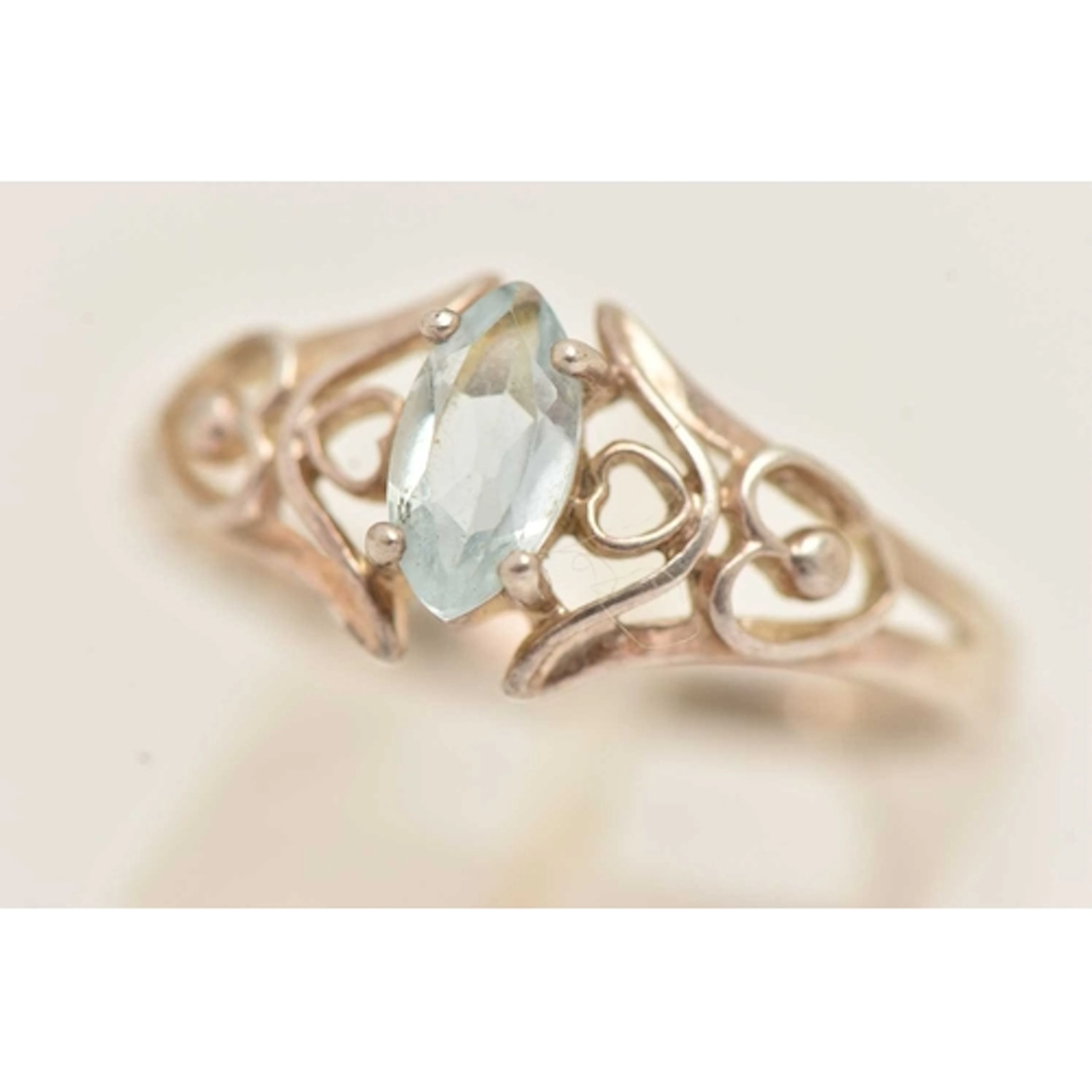 A WHITE METAL GEM SET RING, set with a marquise cut light bl...