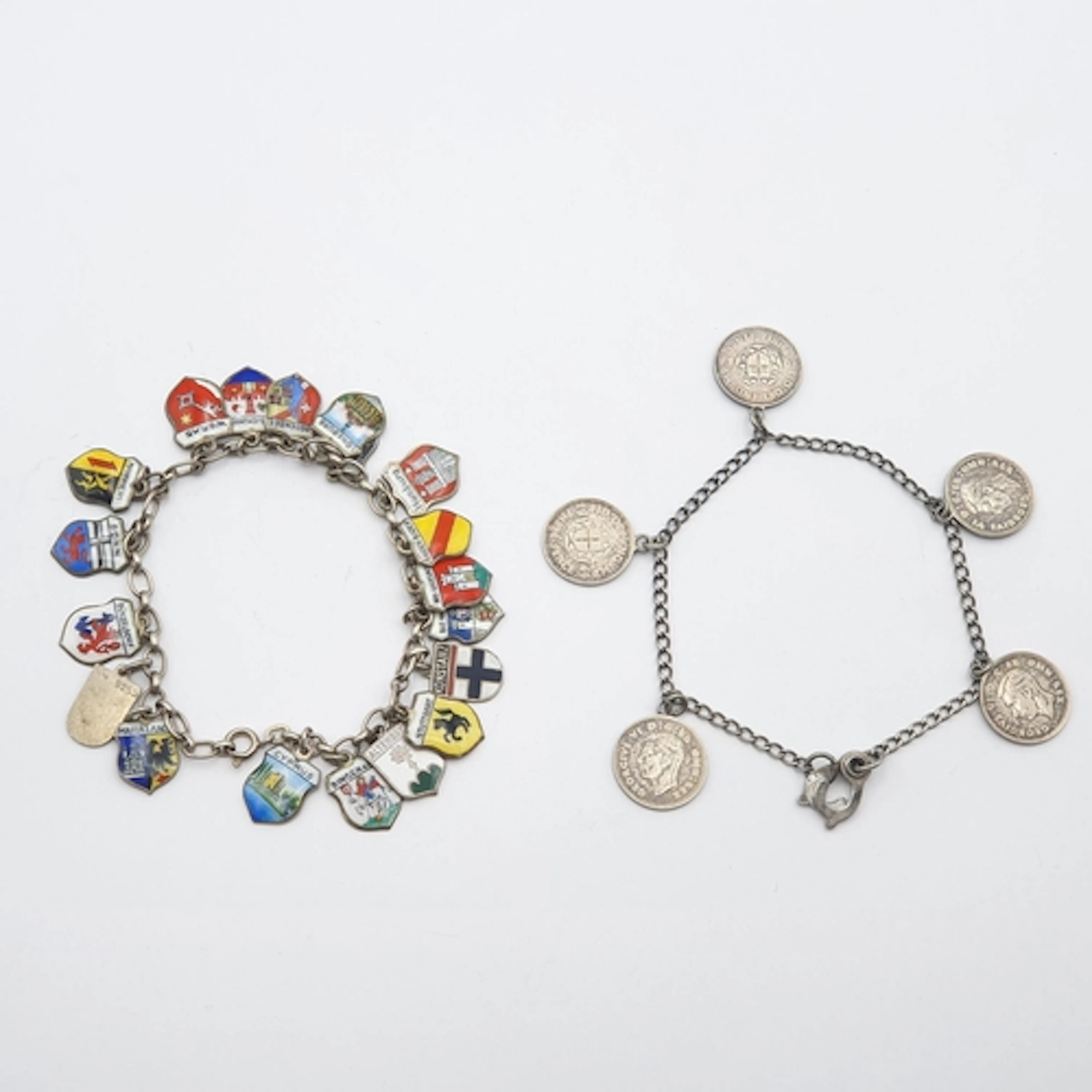 A continental Charm Bracelet suspending multiple European to...