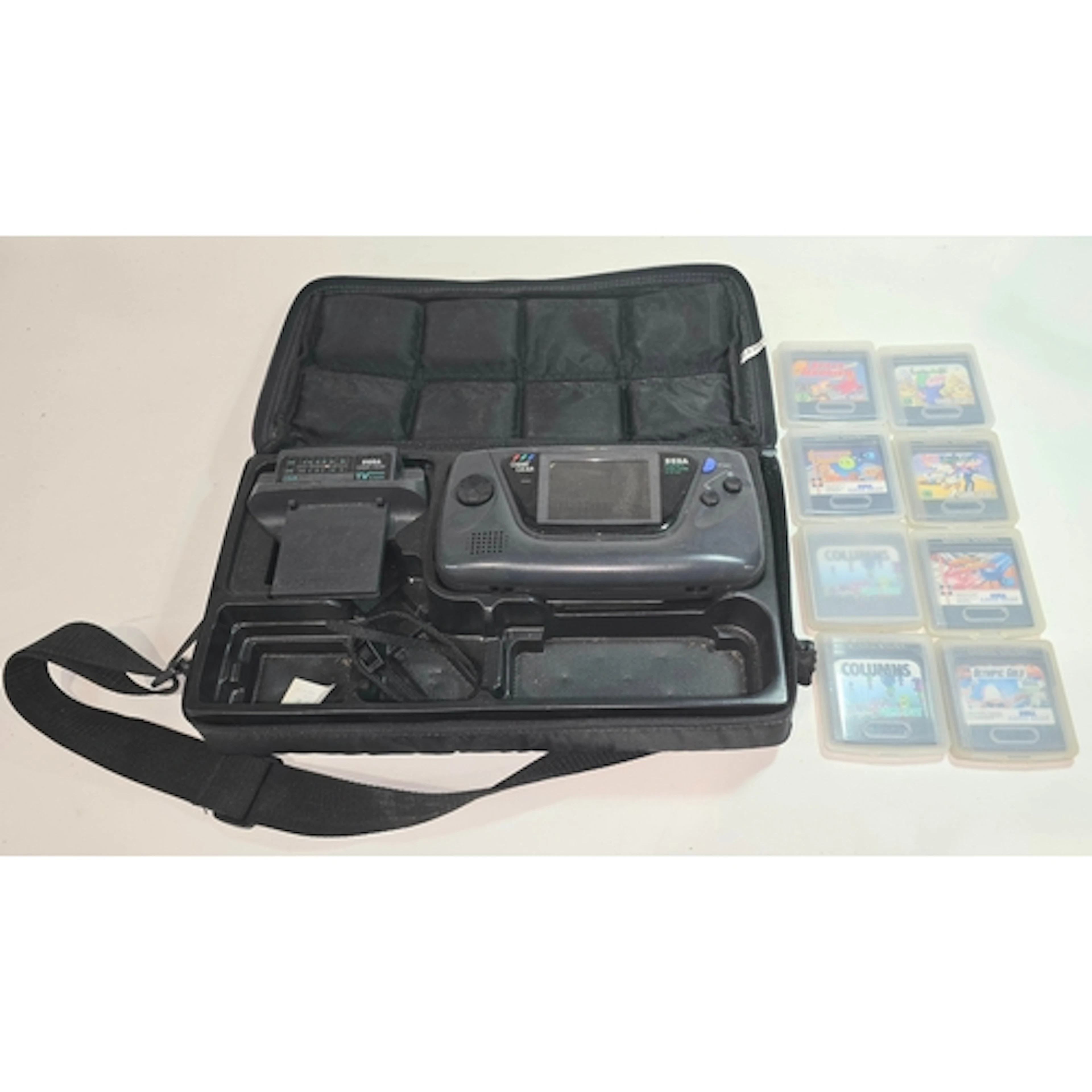 A vintage Sega Game Gear handheld console together with eigh...