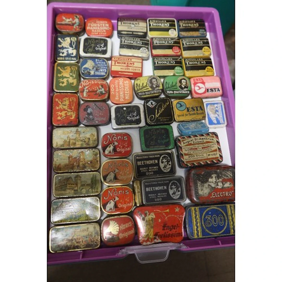A tray of vintage gramophone needle tins
