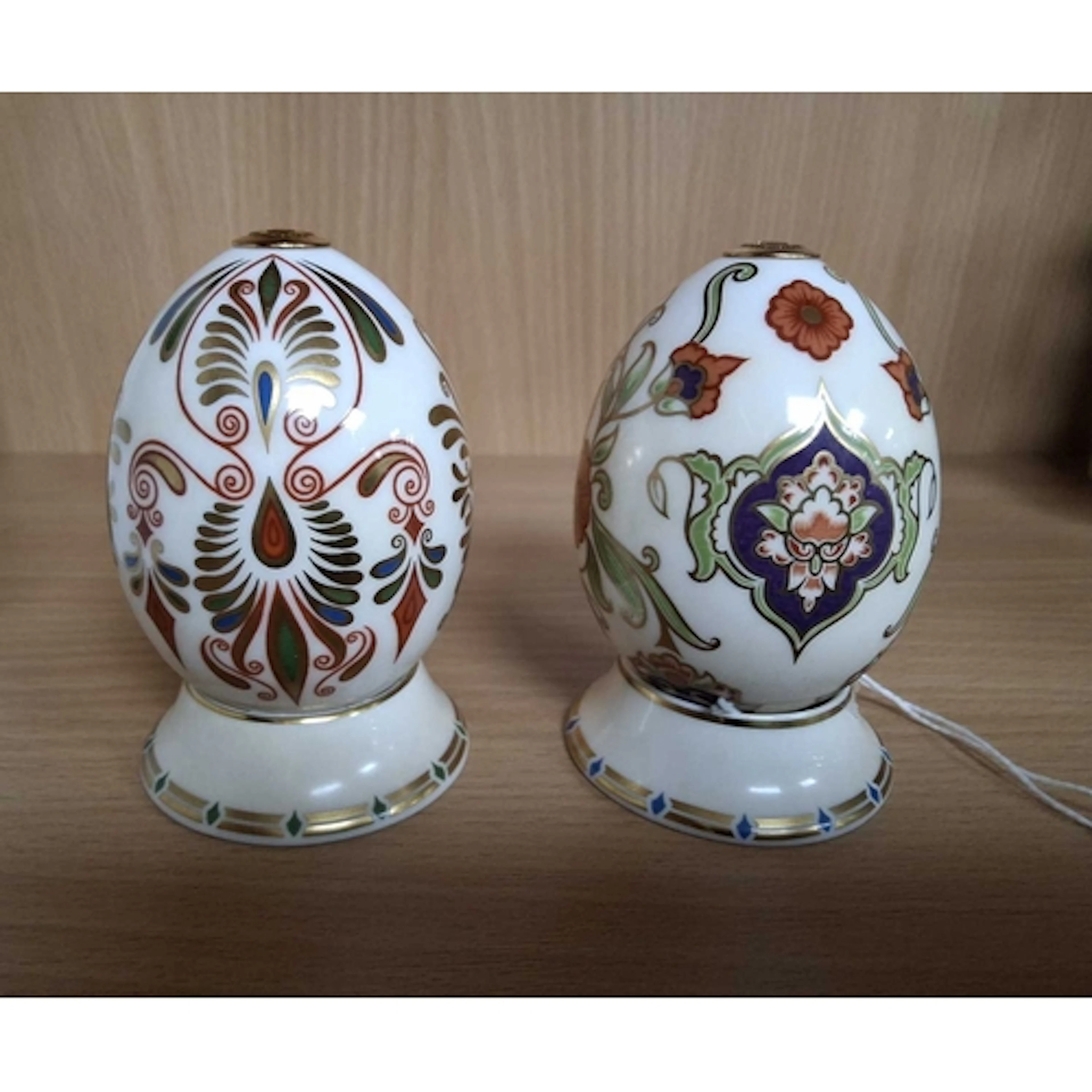 TWO ROYAL CROWN DERBY EGGS AND STANDS, from the 'Eggs from t...