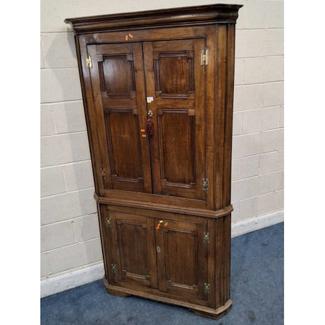 A LARGE OAK CORNER CUPBOARD, fitted with two pairs of cupboa...