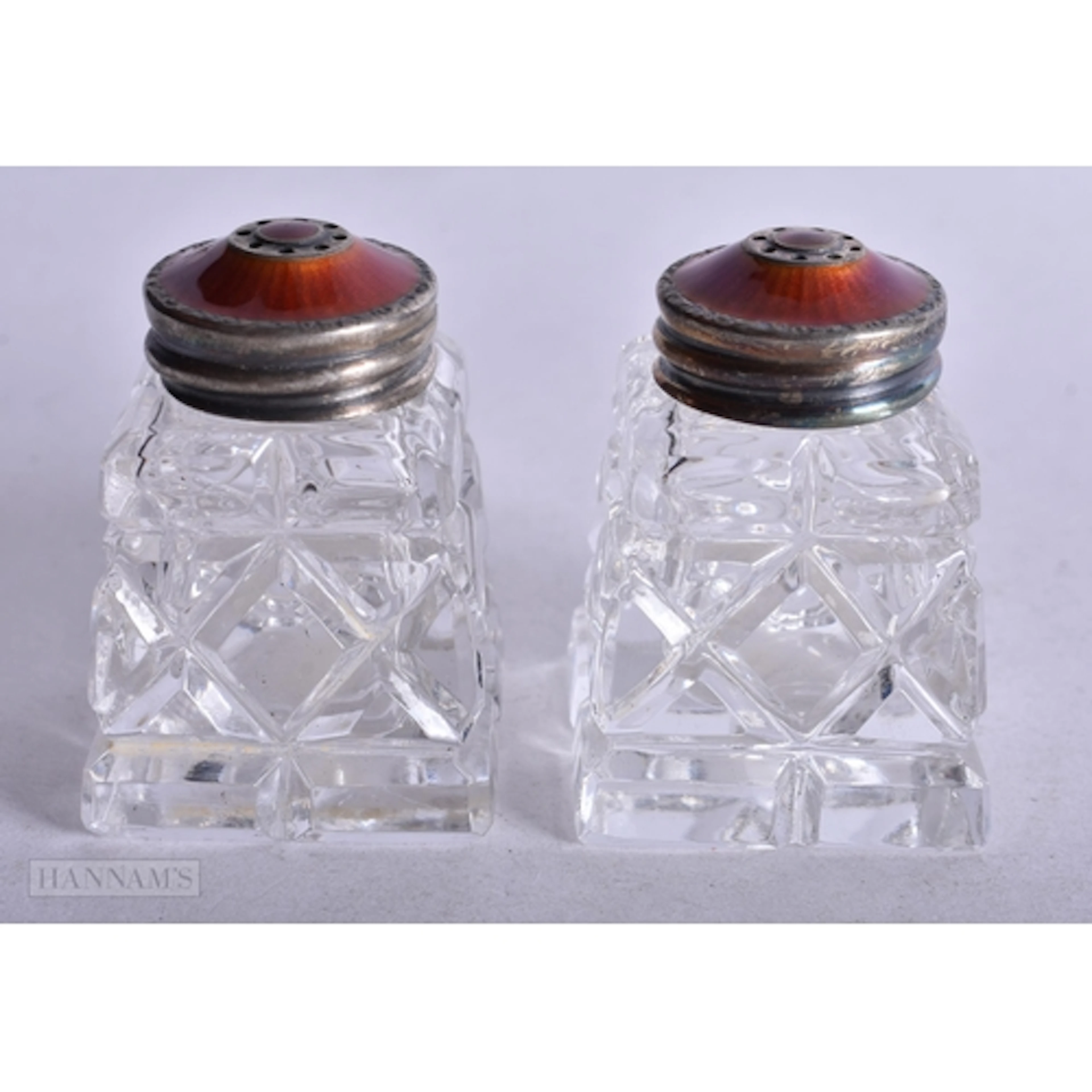 A PAIR OF SILVER AND ENAMEL CONDIMENTS. Silver 8.3 grams. 4....