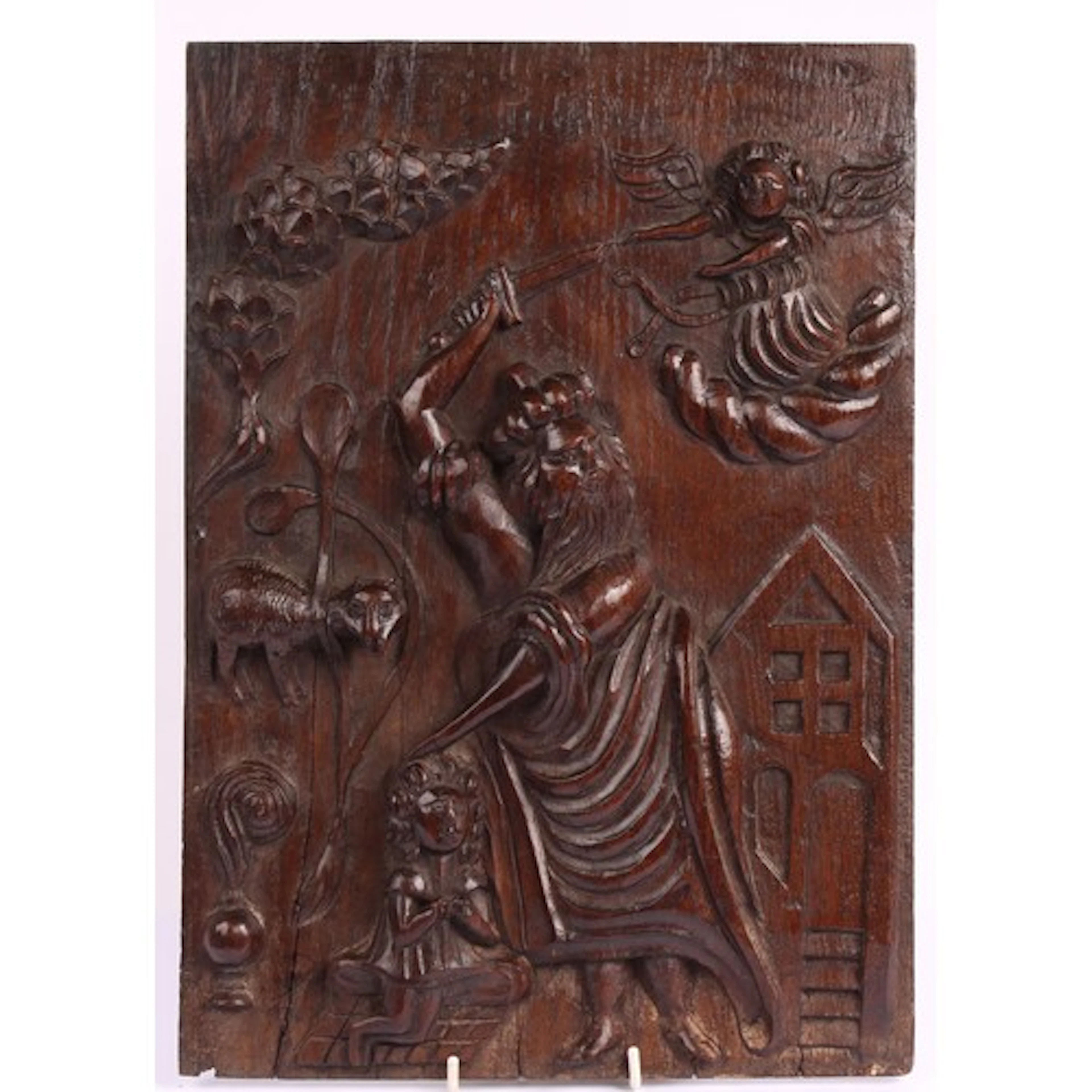 An Elizabeth I oak panel, carved in relief with the sacrific...