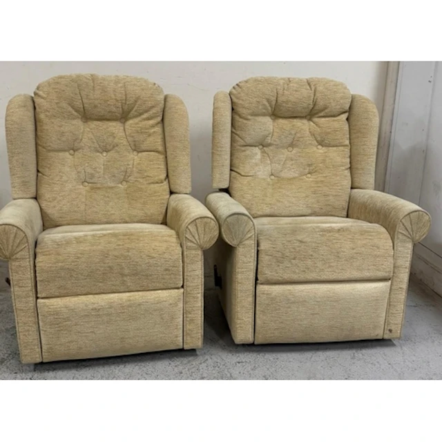 A pair of pale yellow upholstered button back reclining armc...