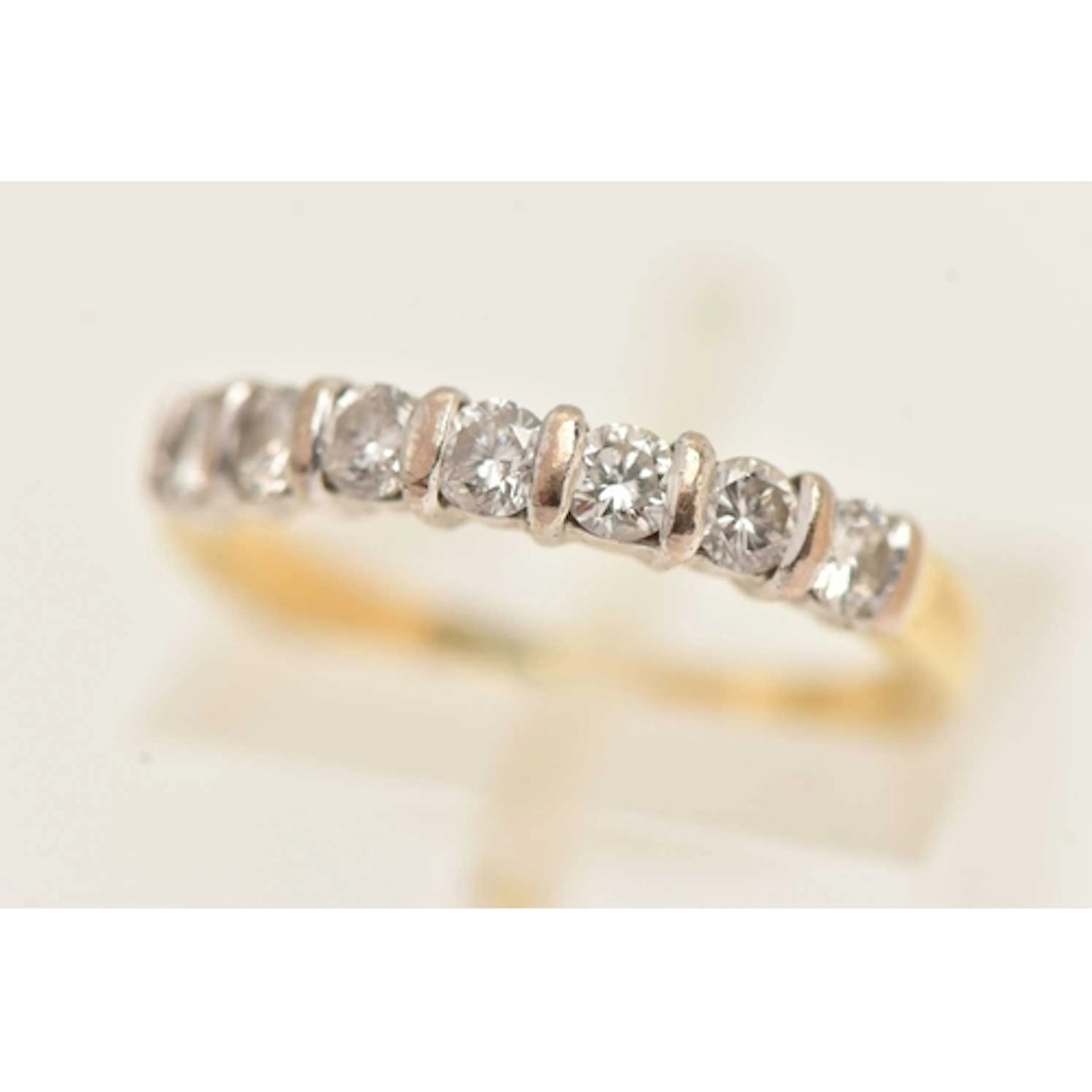 AN 18CT GOLD SEVEN STONE DIAMOND RING, seven round brilliant...