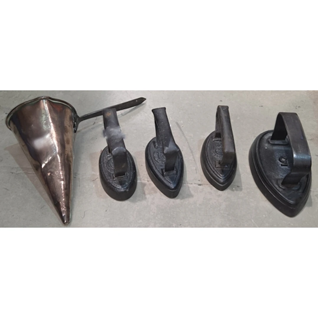 A conical copper cider mull, Four various cast iron sad iron...