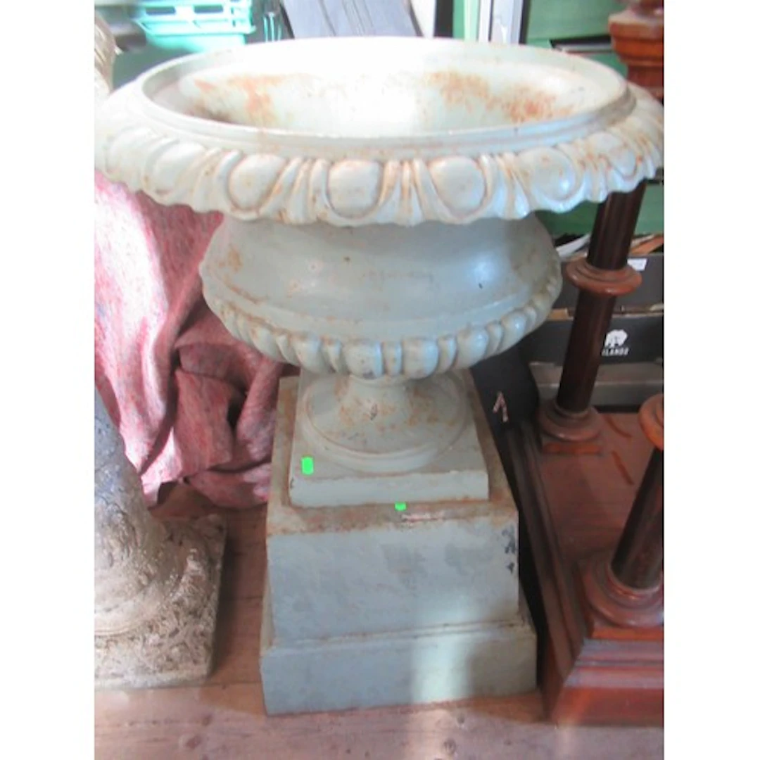 A metal urn and plinth