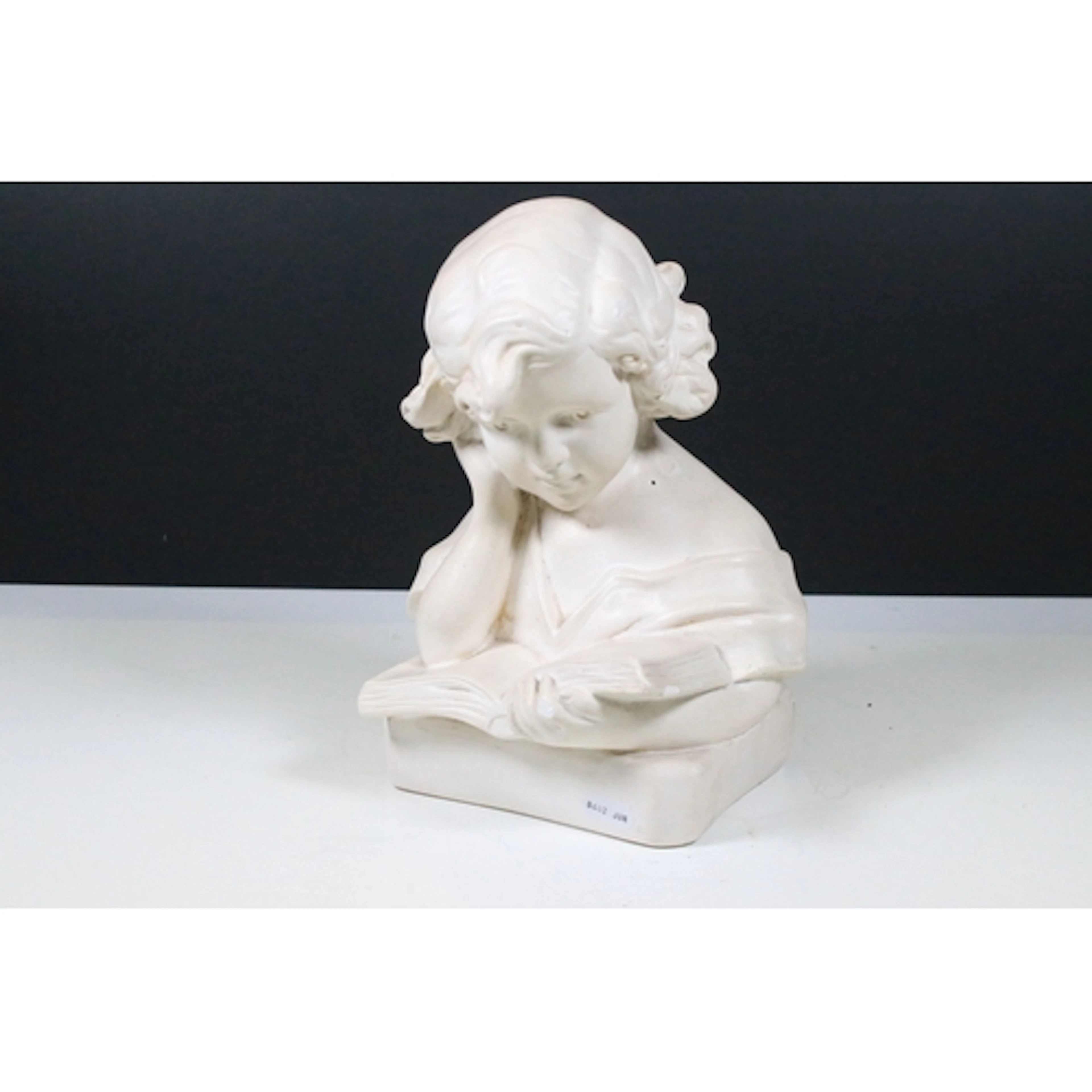 20th century Victorian-style plaster bust of a child reading...