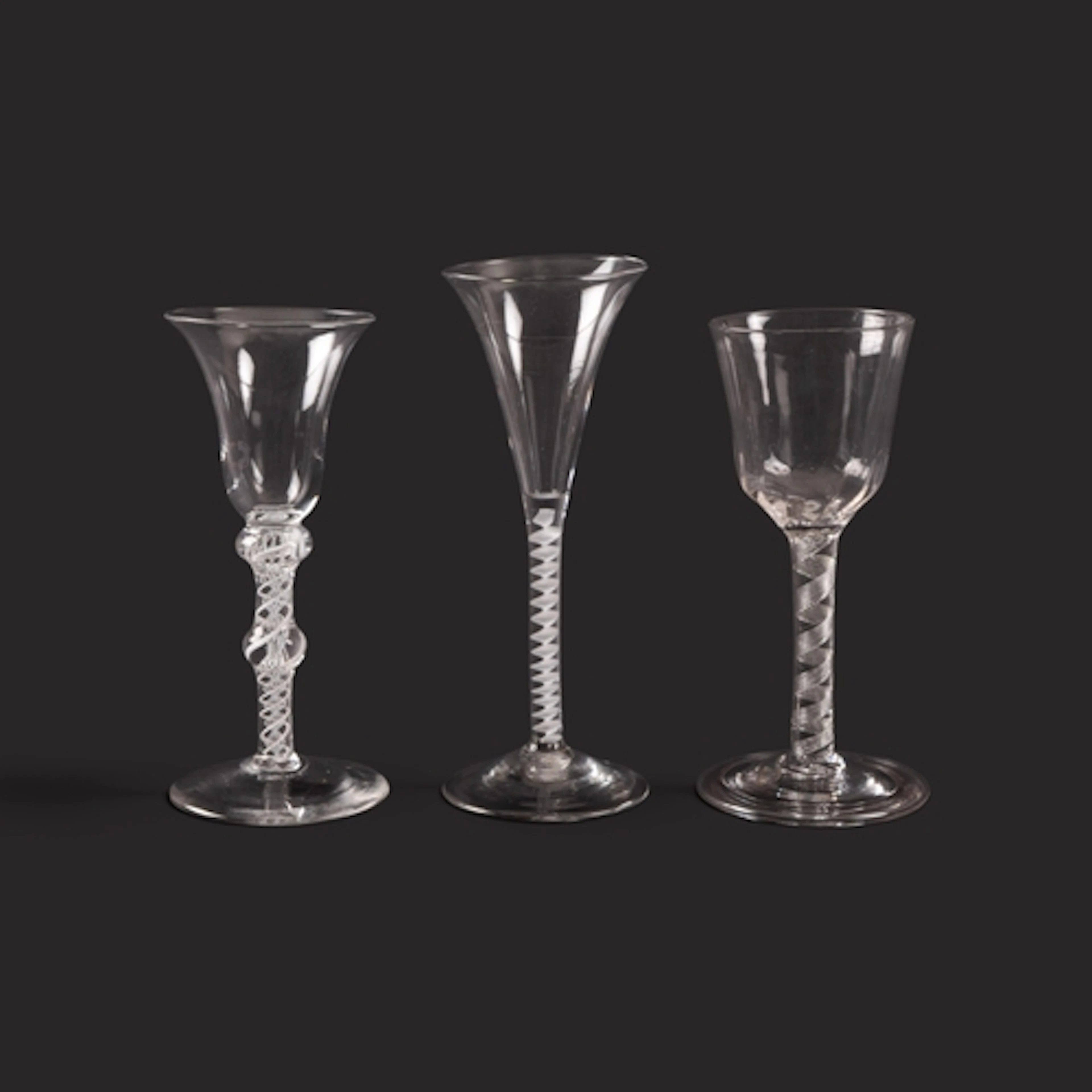 Three wine glasses, c.1755-65, one with a moulded round bowl...