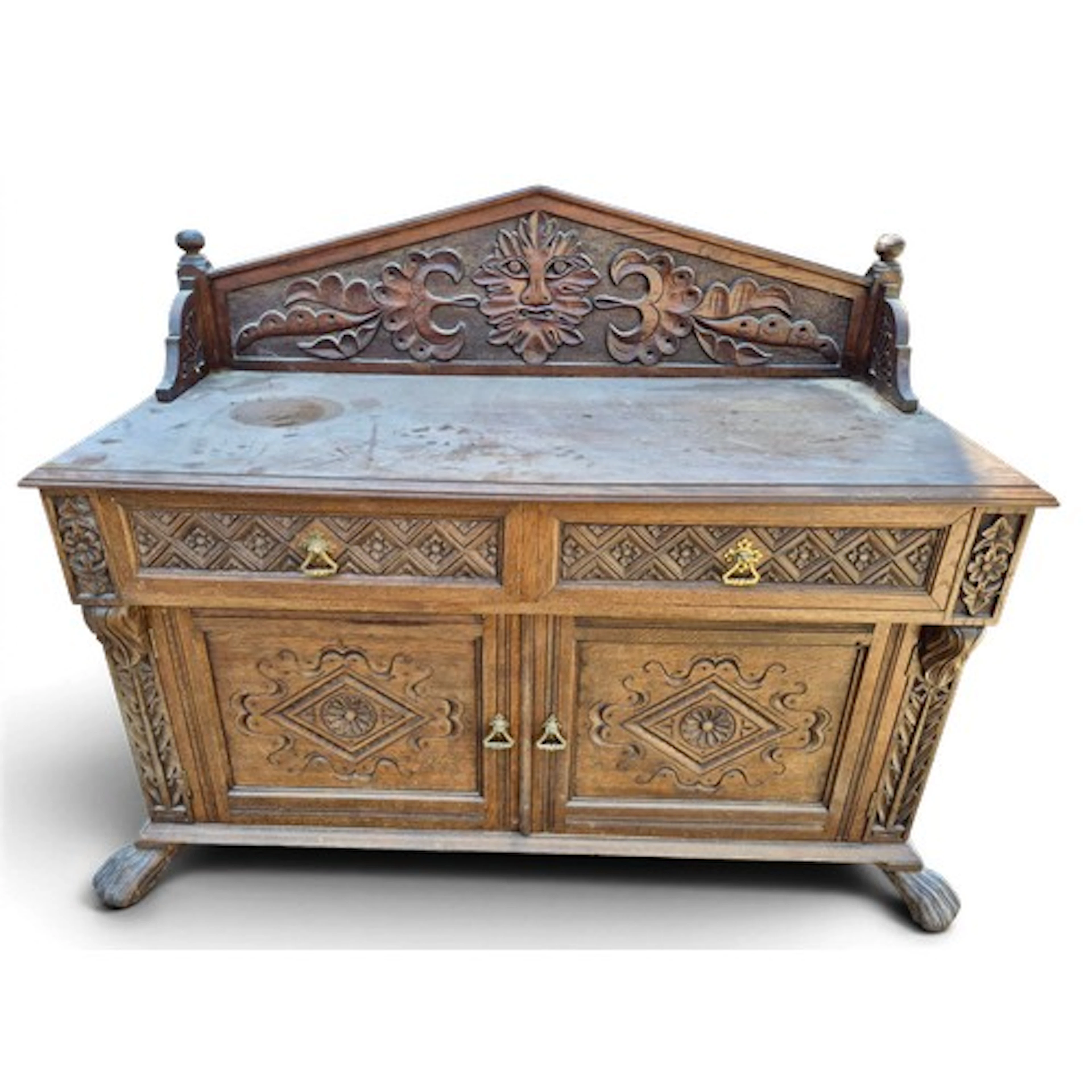 An Edwardian carved oak sideboard with two drawers over two ...