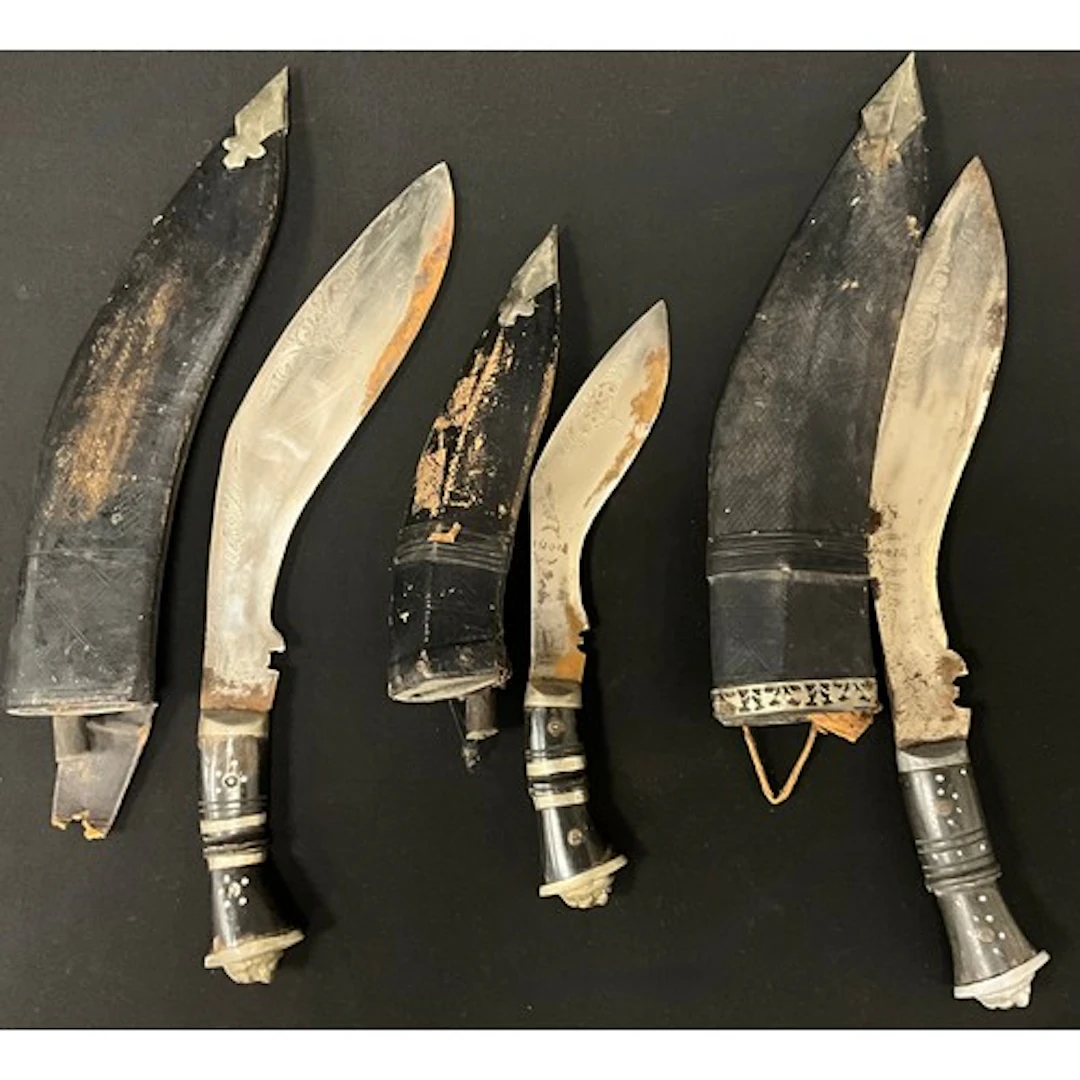 Three Kukri knives with single edged blade decorated with pu...