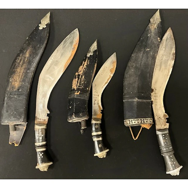 Three Kukri knives with single edged blade decorated with pu...