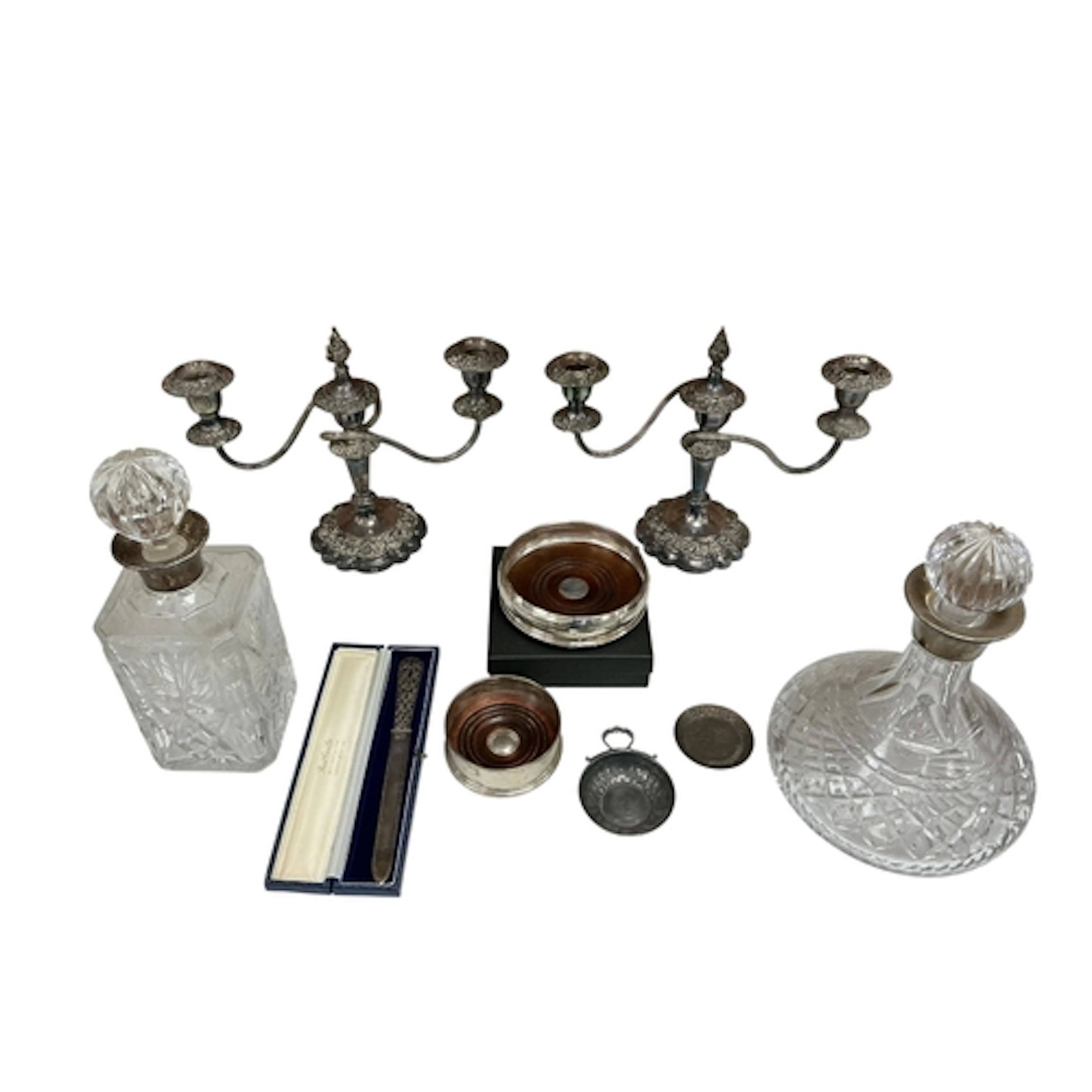 Two modern silver bottle coasters, a paper knife, wine taste...