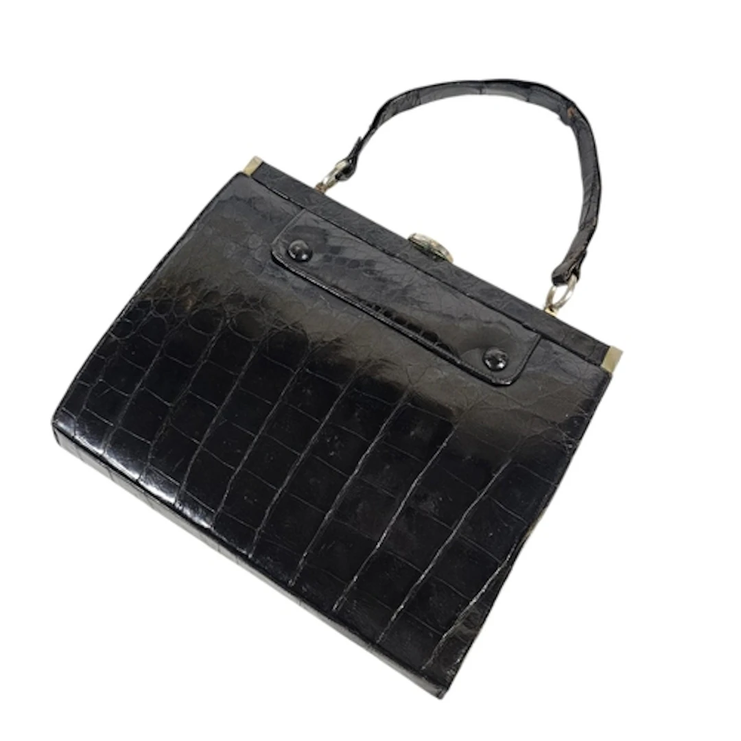 A VINTAGE BLACK CROCODILE SKIN FRAMED HANDBAG Highly polishe...