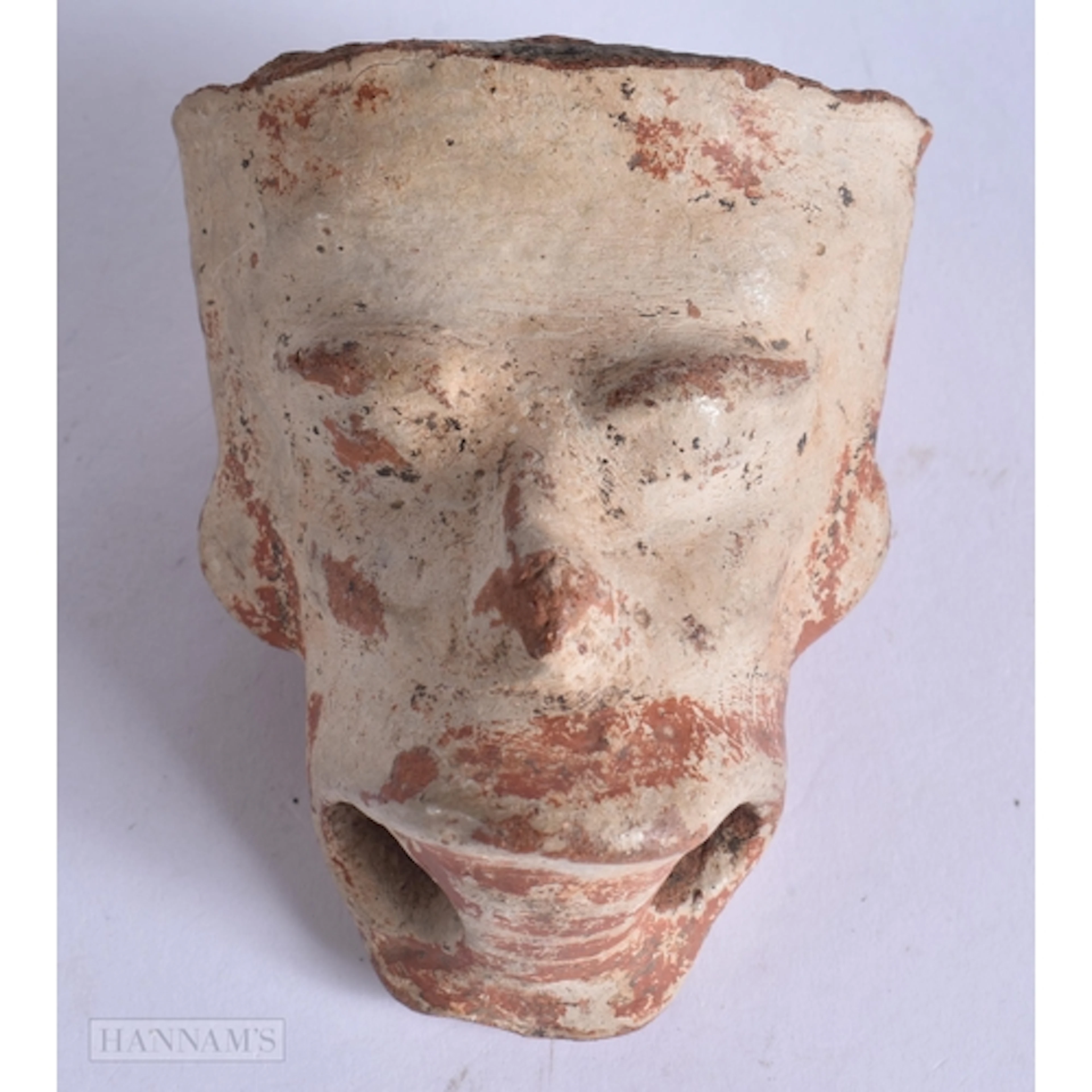 AN EARLY SOUTH AMERICAN TRIBAL POTTERY RATTLE formed as a he...