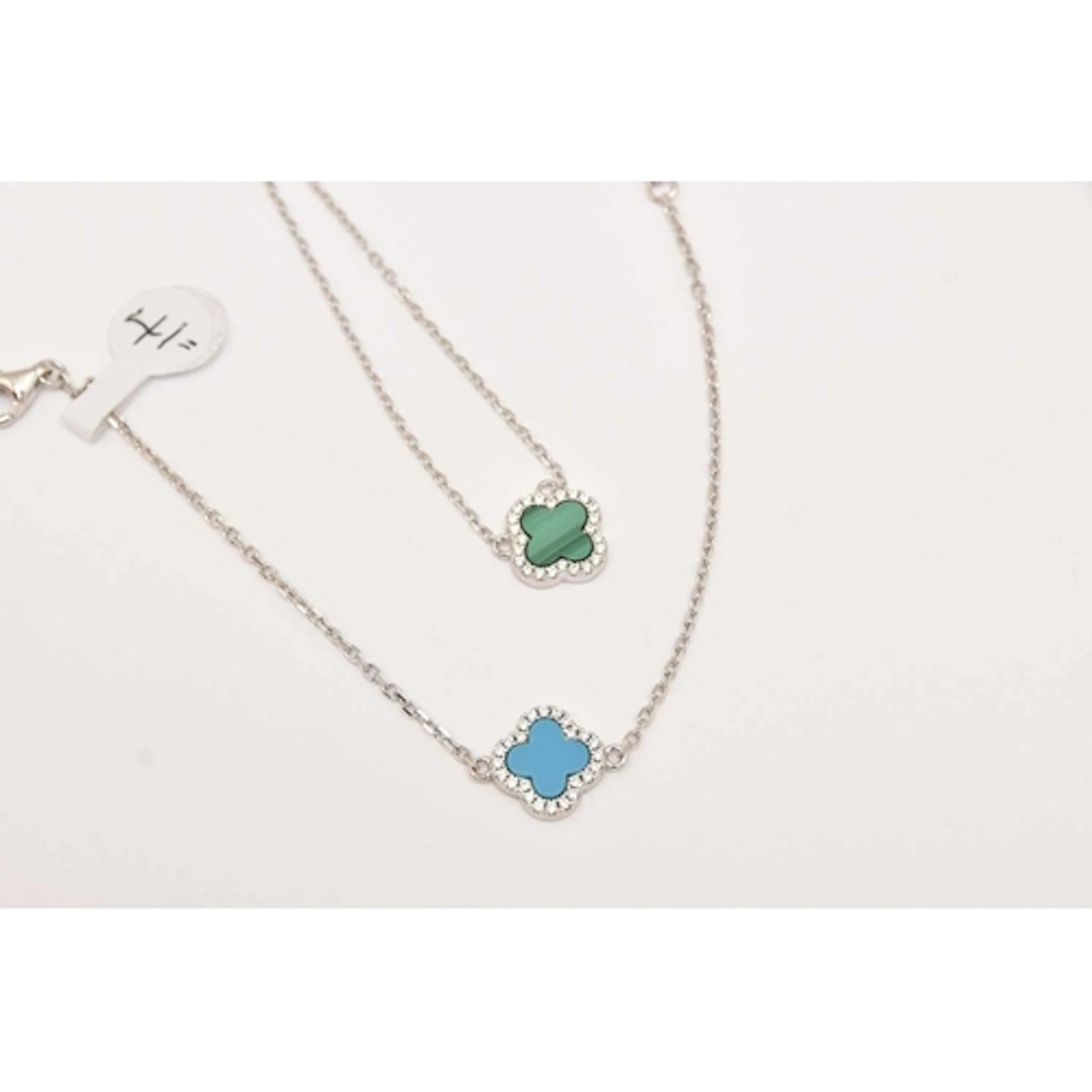 A WHITE METAL NECKLACE AND BRACELET, quatrefoil design set w...