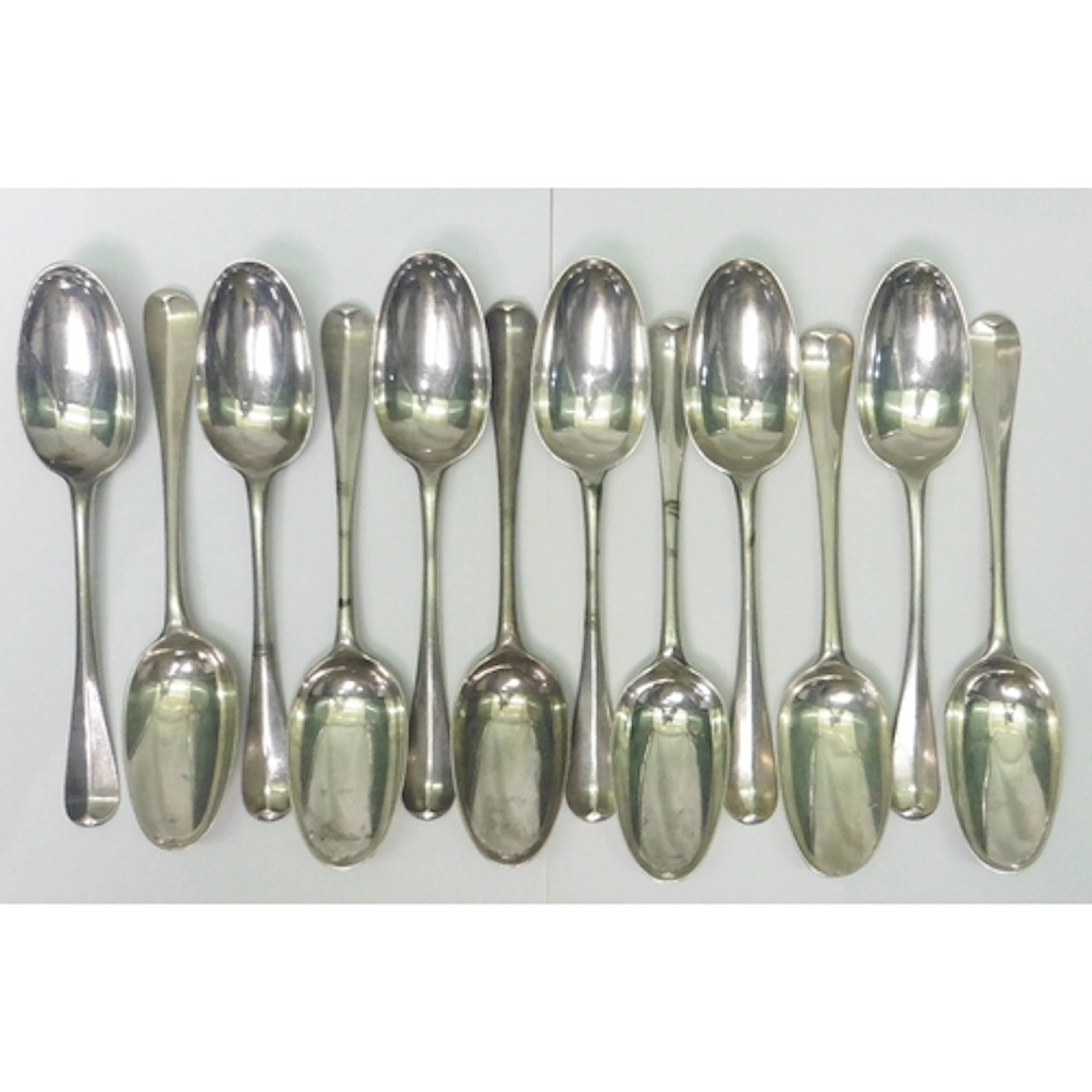 A matched set of twelve George I rat tailed table spoons bea...